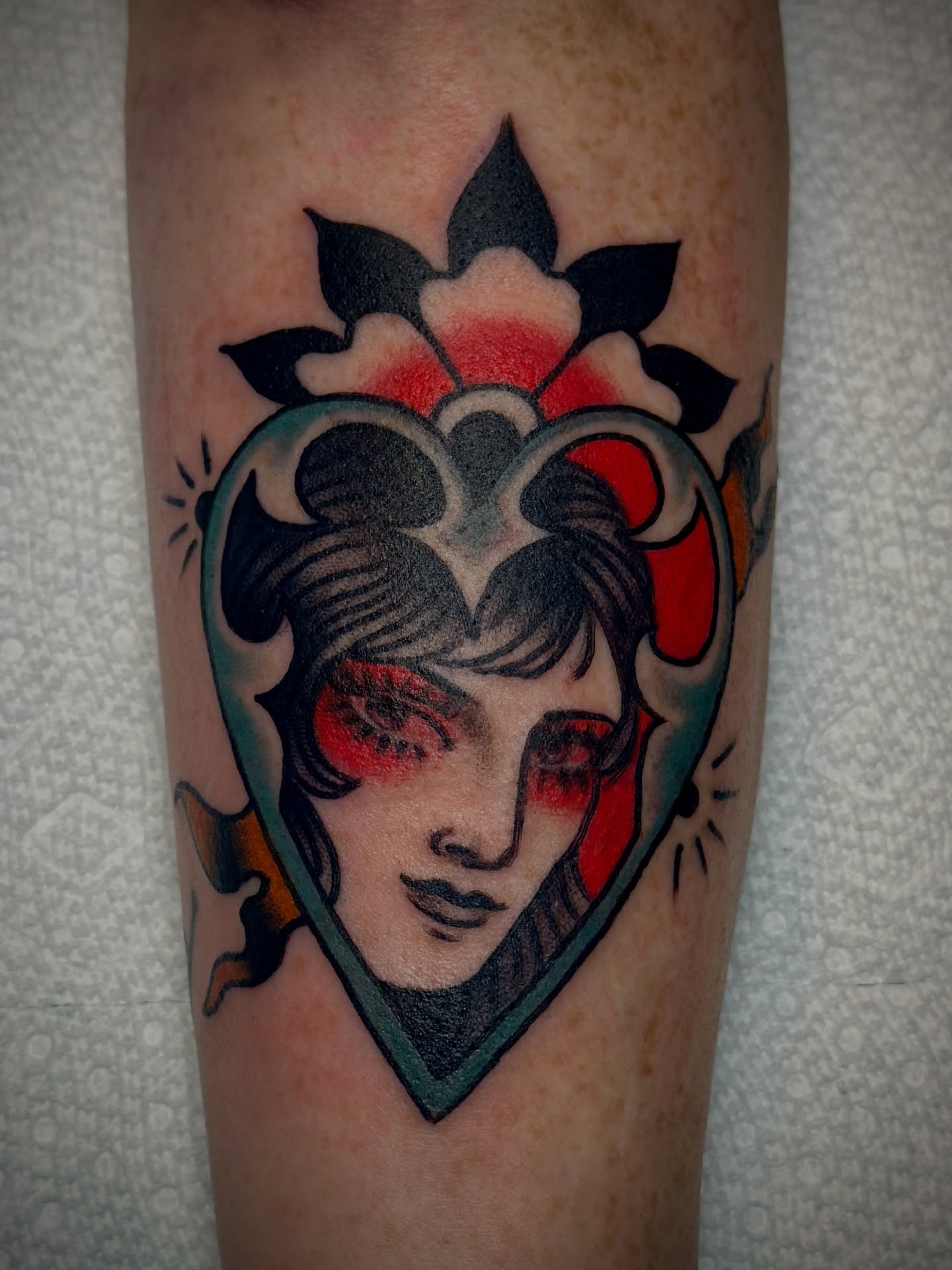 Woman's face American traditional tattoo on the forearm by Holly Ellis, San Francisco, California