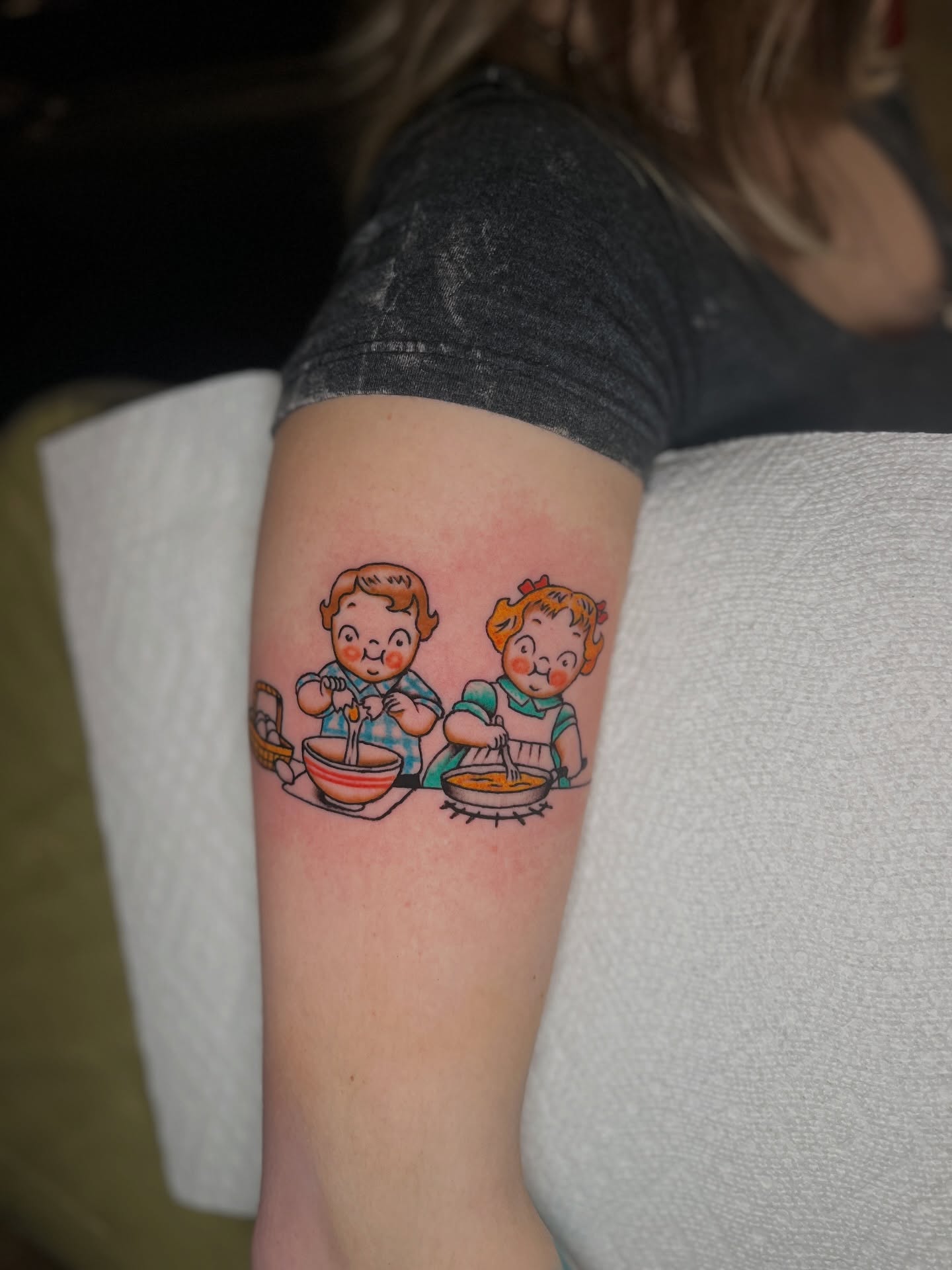 Cooking children American traditional tattoo on the forearm by Andrew Storm
