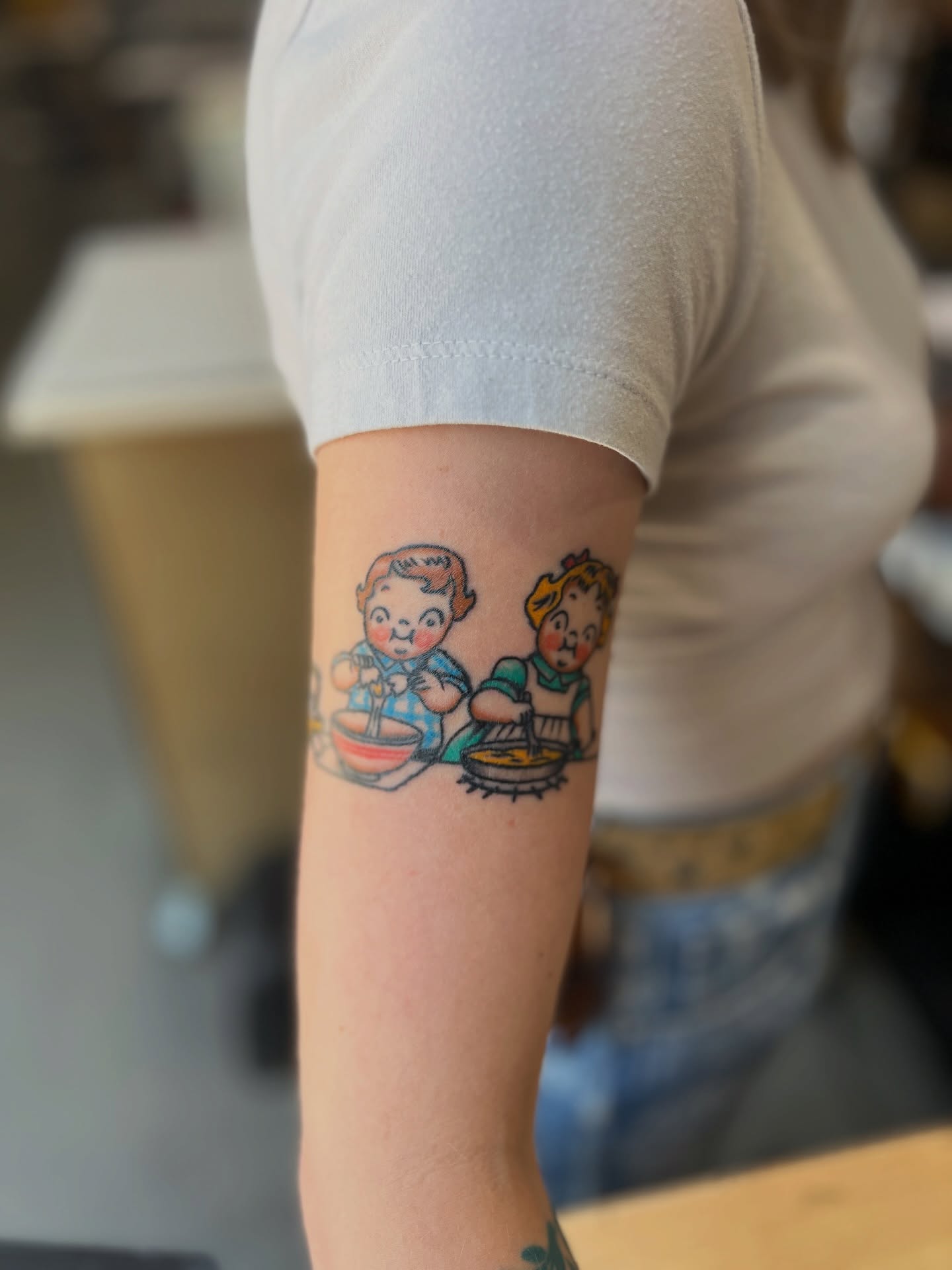 Cooking children American traditional tattoo on the forearm by Andrew Storm