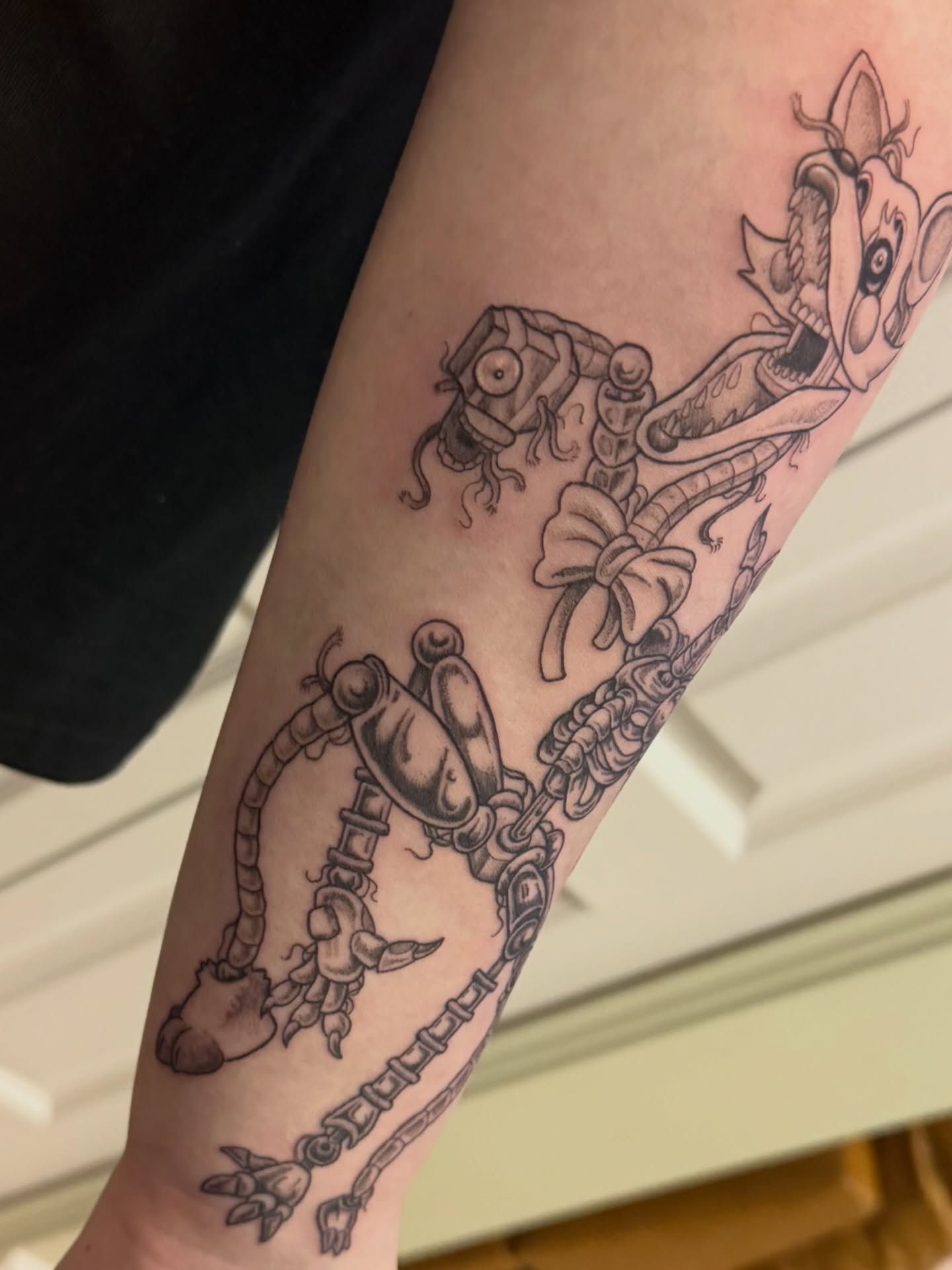 Robotic creature black and grey tattoo on the forearm by 𝑲𝒂𝒊𝒕 𝑨𝒏𝒅𝒆𝒓𝒔𝒆𝒏