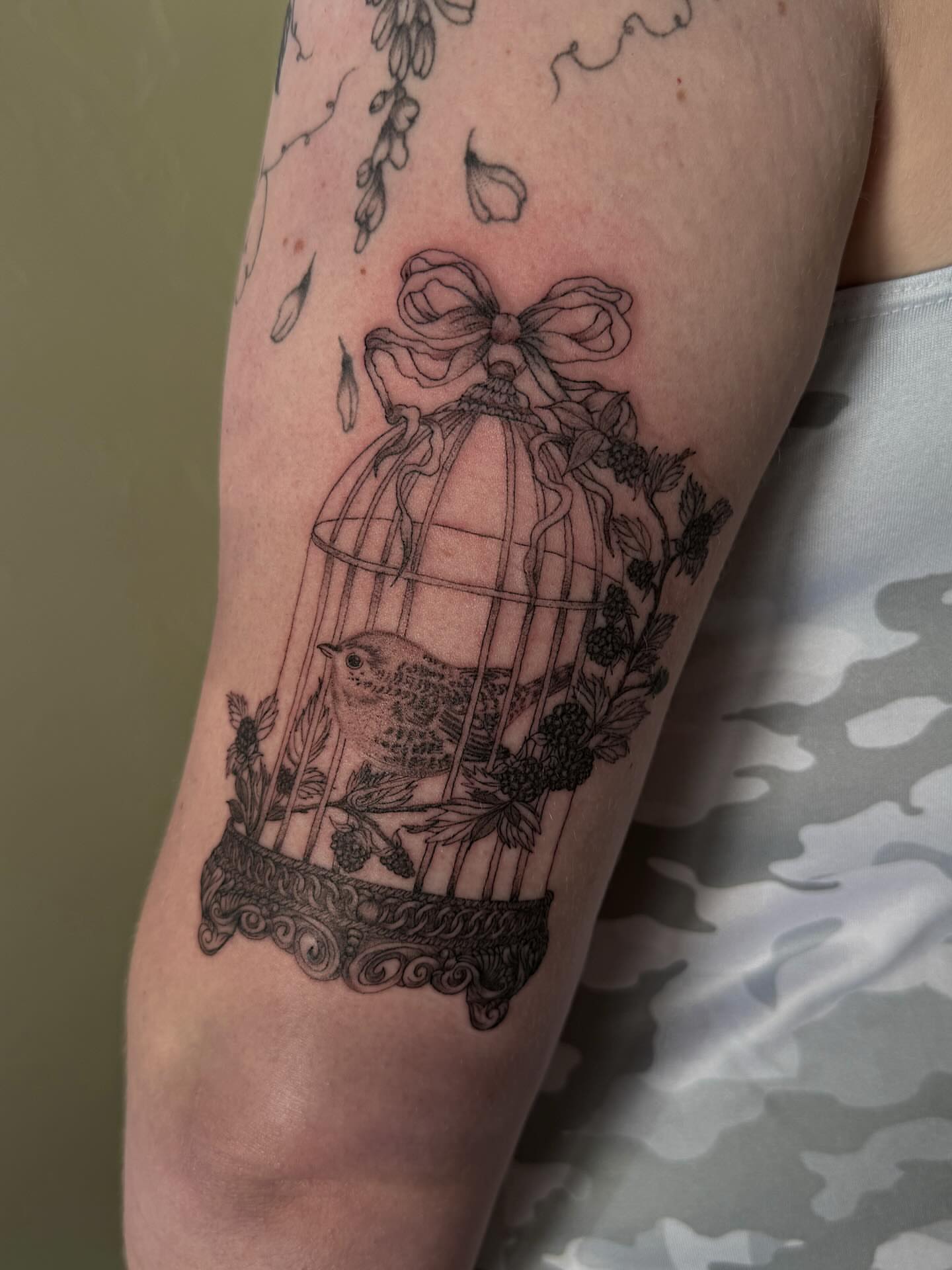 Bird in cage black and grey tattoo on the forearm by Shelby Lynn Bayles, Ogden, Utah