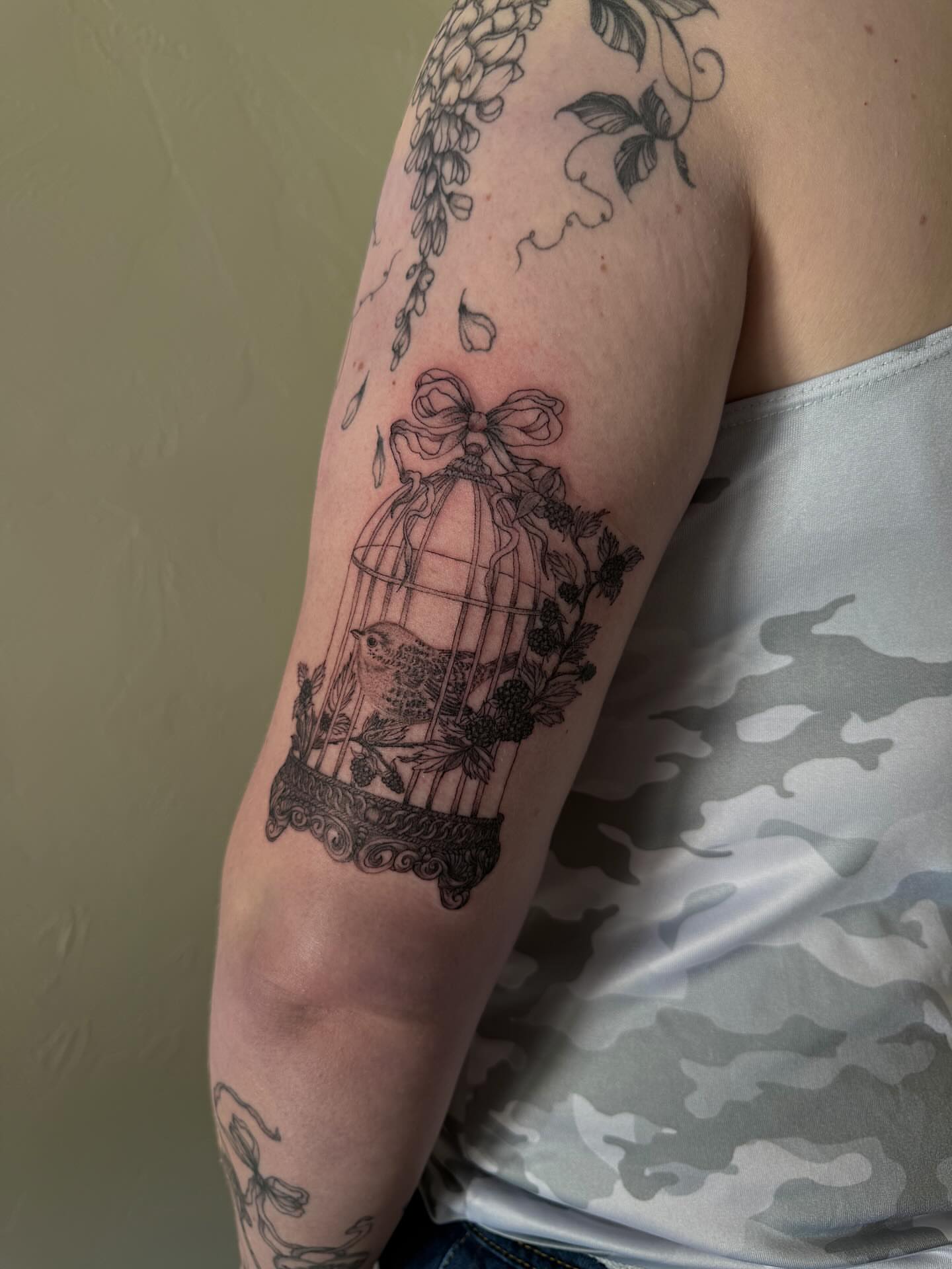 Bird in cage black and grey tattoo on the forearm by Shelby Lynn Bayles, Ogden, Utah