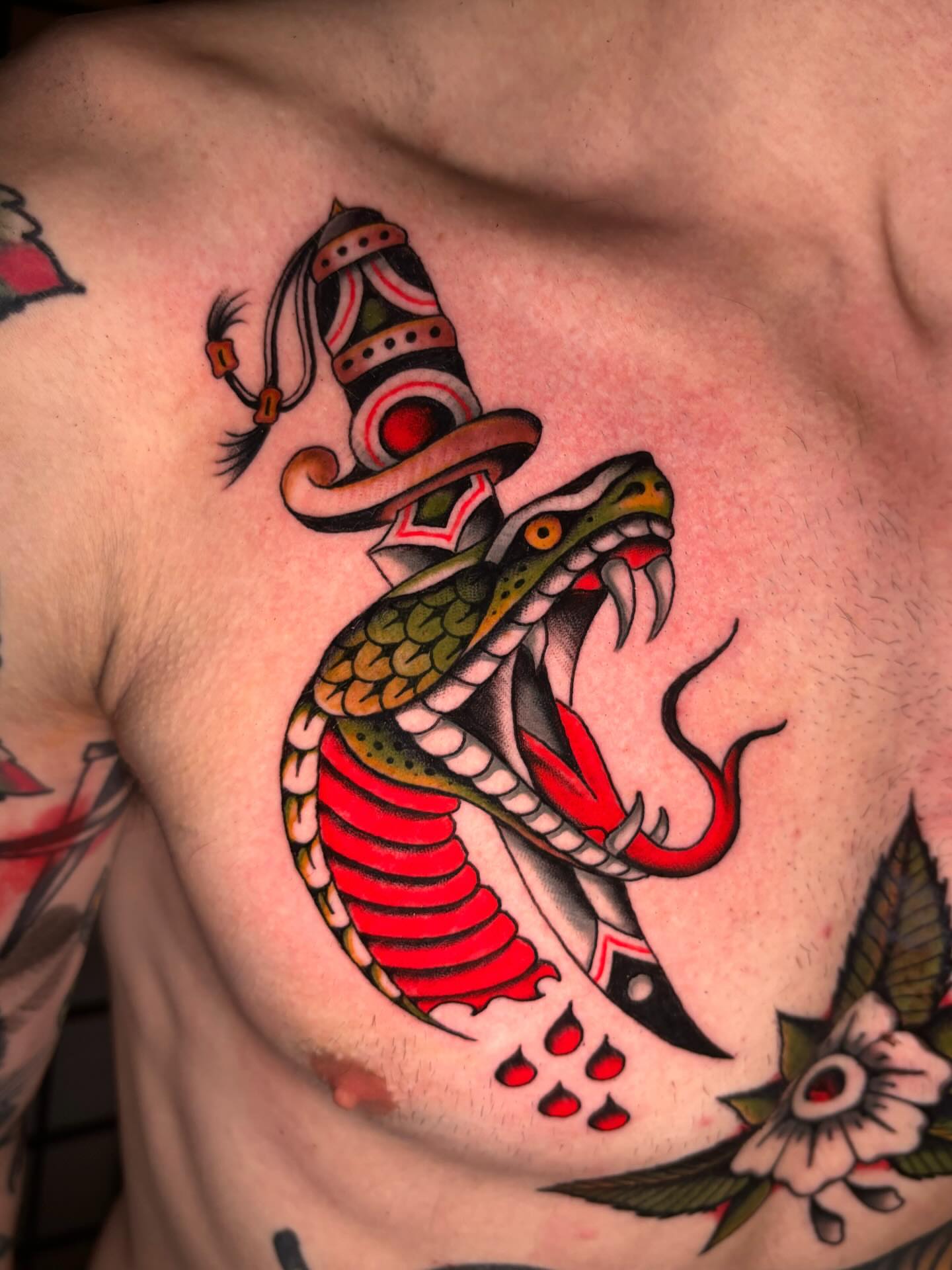 Snake American traditional tattoo on the chest by Jesse Smith, Chicago, Illinois