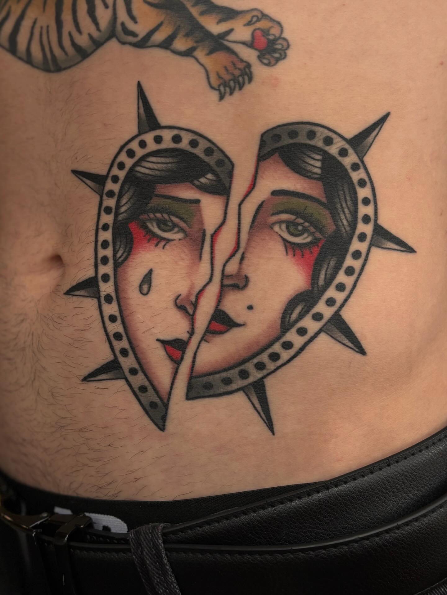 Split face American traditional tattoo on the ribs by Jesse Smith, Chicago, Illinois