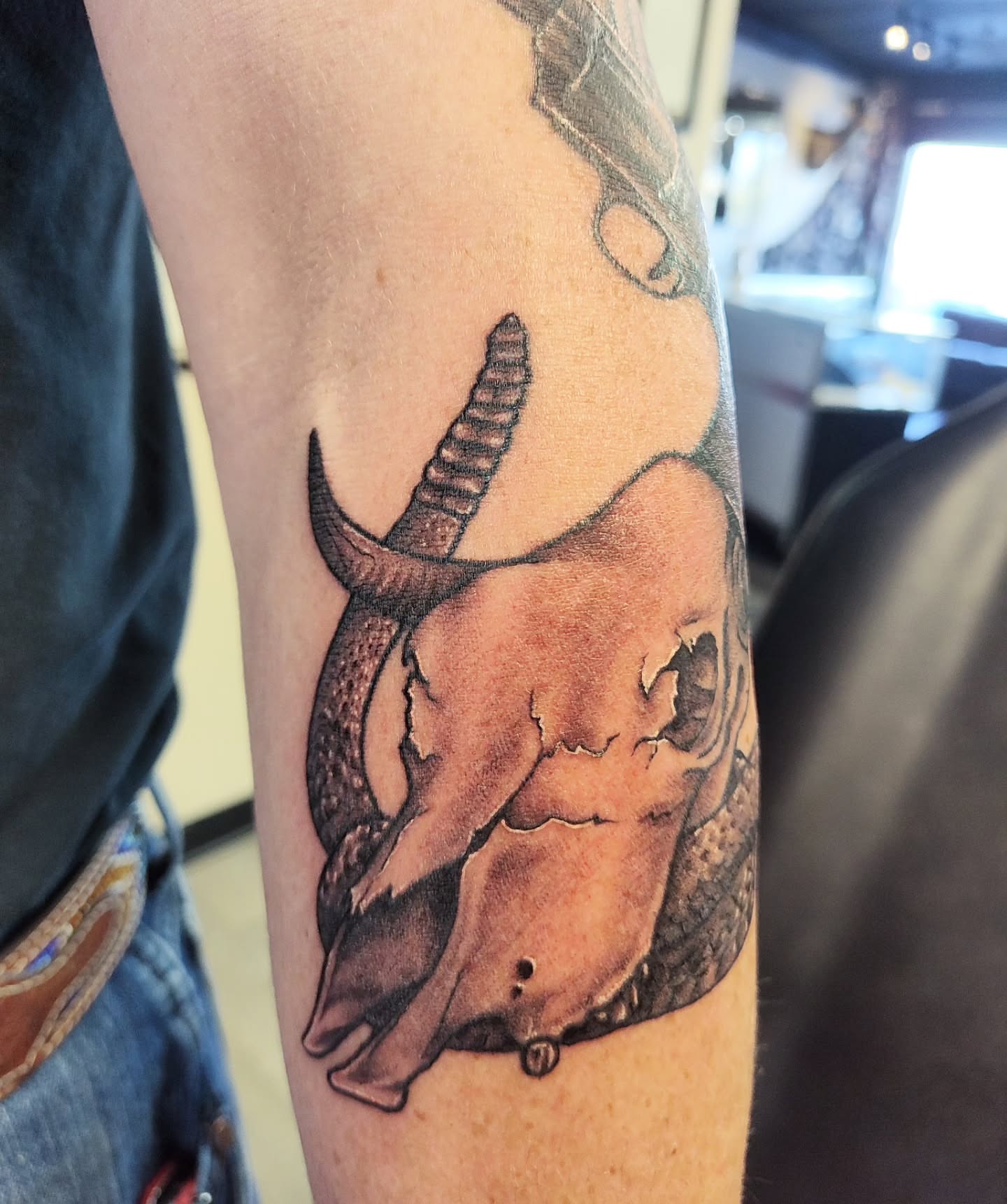 Bull skull realism tattoo on the forearm by Mercury