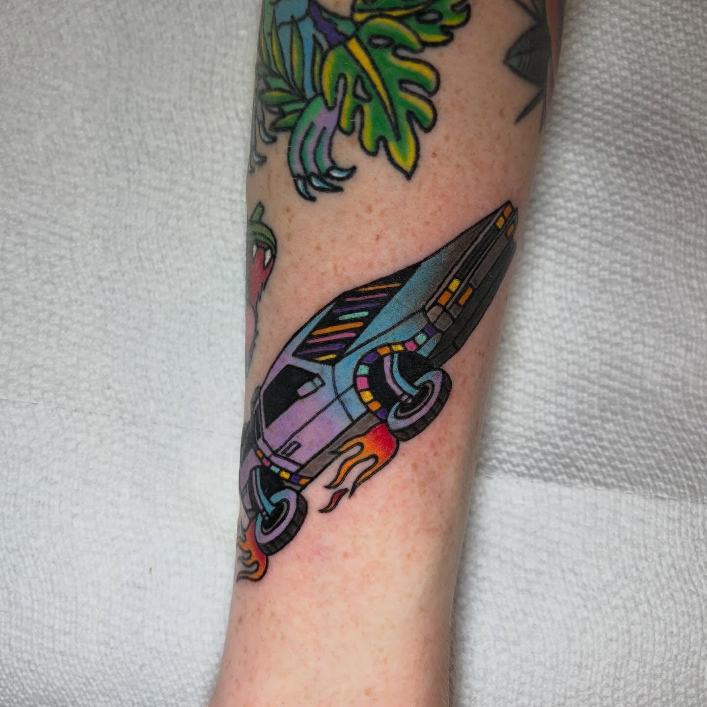 Futuristic car American traditional tattoo on the forearm by Juliet Miller