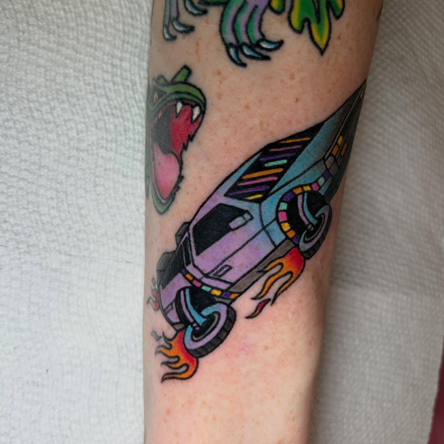 Futuristic car new school tattoo on the forearm by Juliet Miller