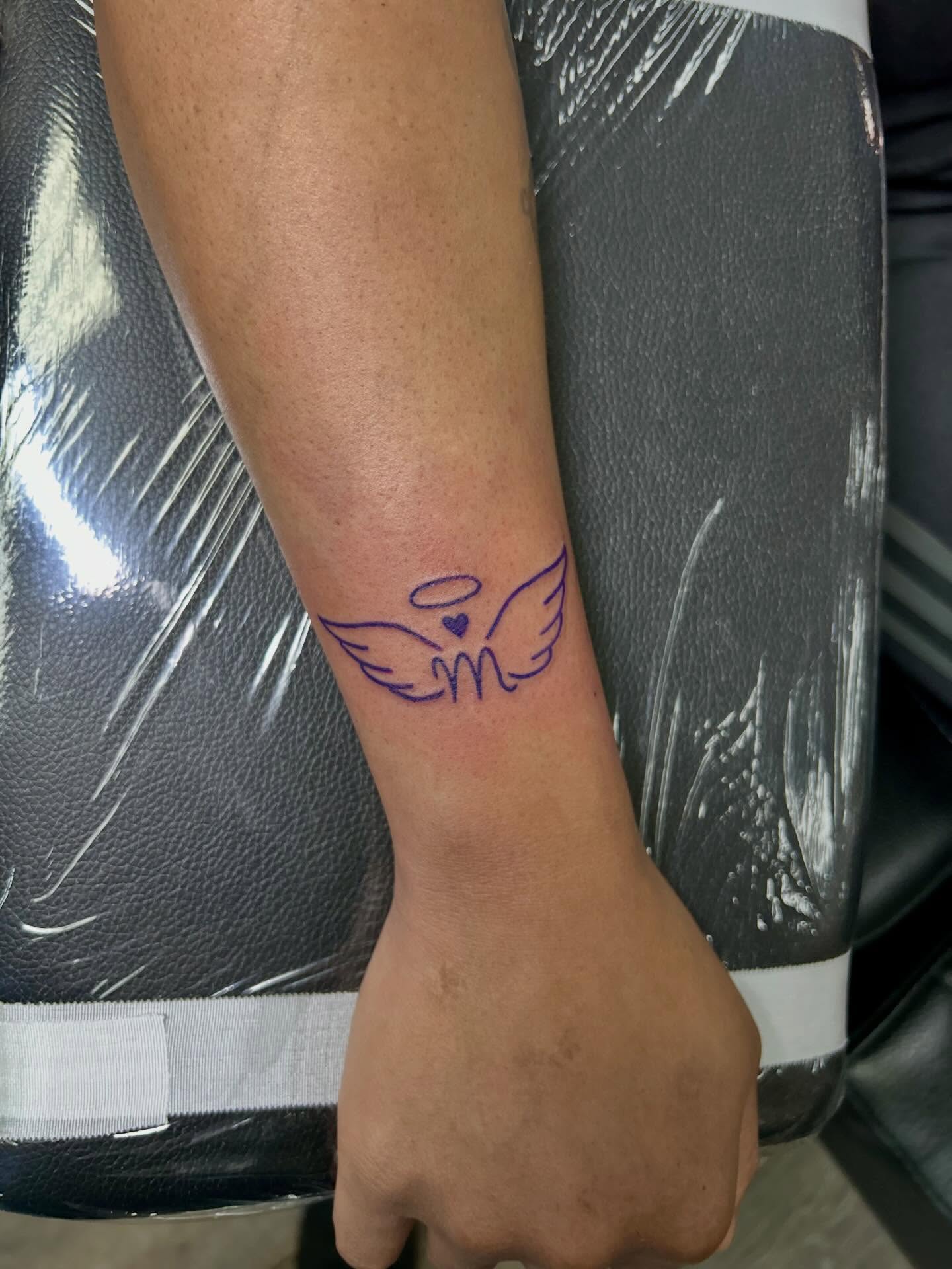 Angel wings fine line tattoo on the forearm by Bjorn Bjornstad, Dubuque, Iowa