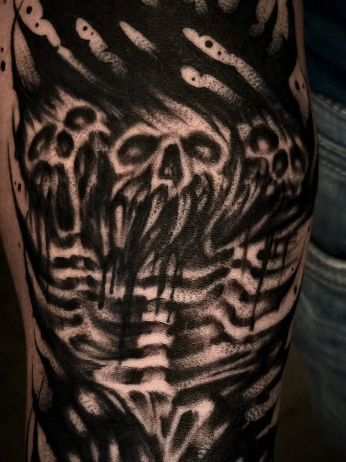 Skulls and worms dark realism tattoo on the forearm by Thomas Martinez