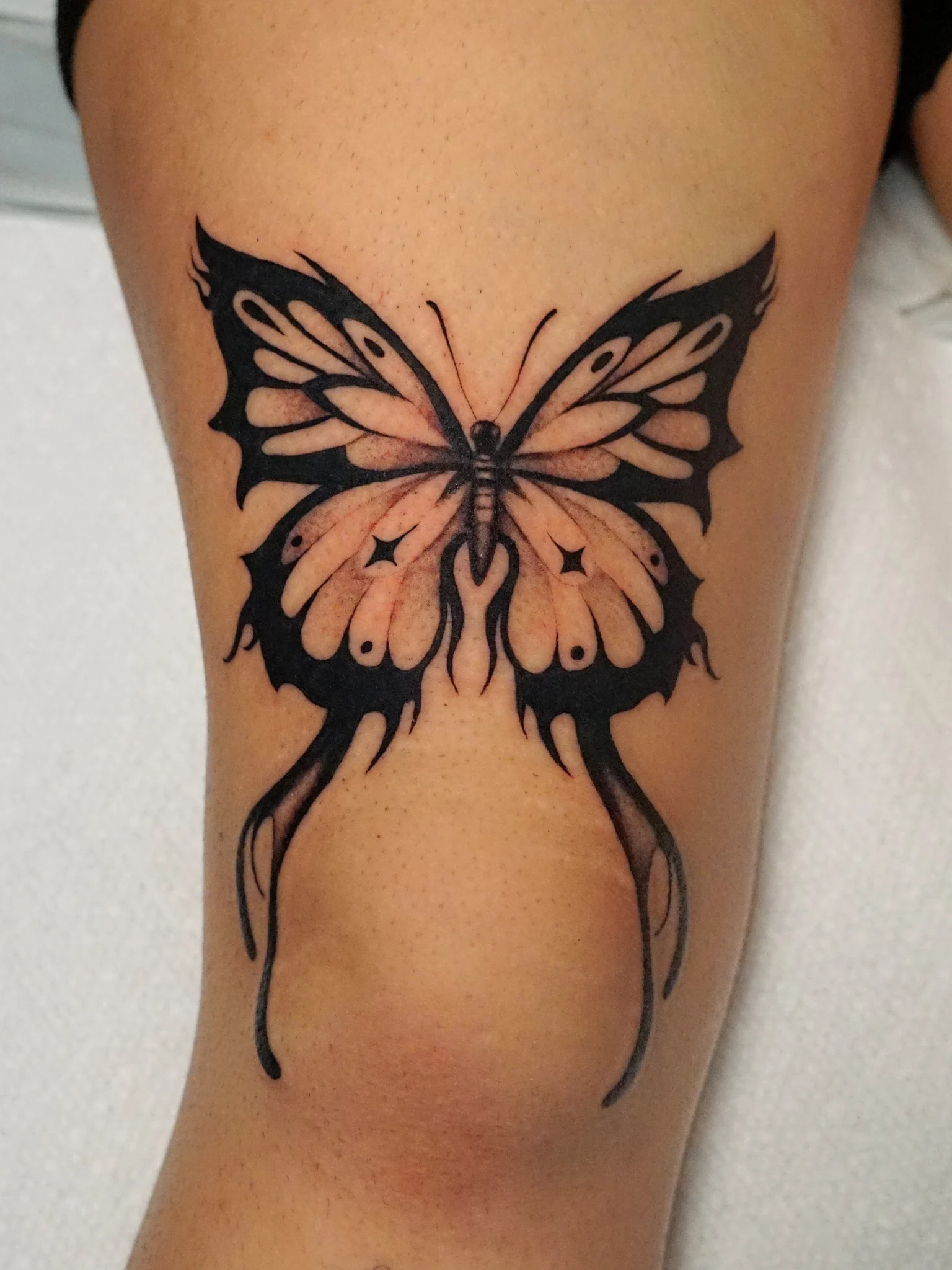 Butterfly black and grey tattoo on the thigh by kylie, San Antonio, Texas