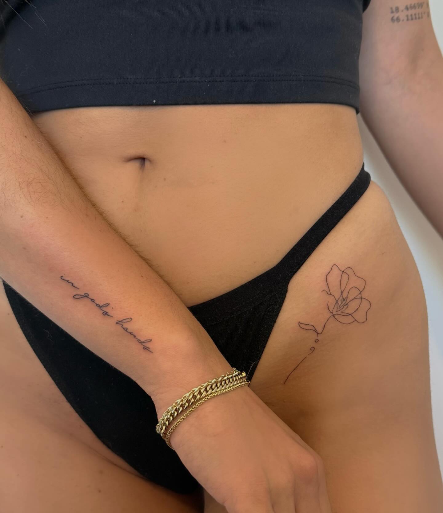Flower fine line tattoo on the thigh by Lexie Decker, Canton, Ohio