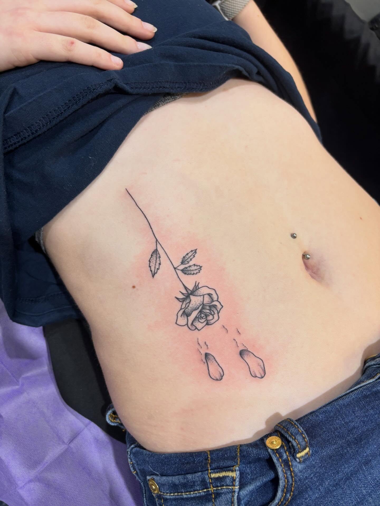 Rose black and grey tattoo on the ribs by Malia Clark
