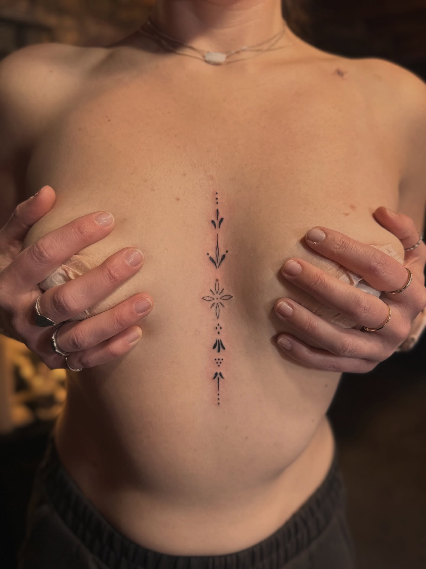 Geometric pattern dotwork tattoo on the chest by Lunette : a little moon as simple as that