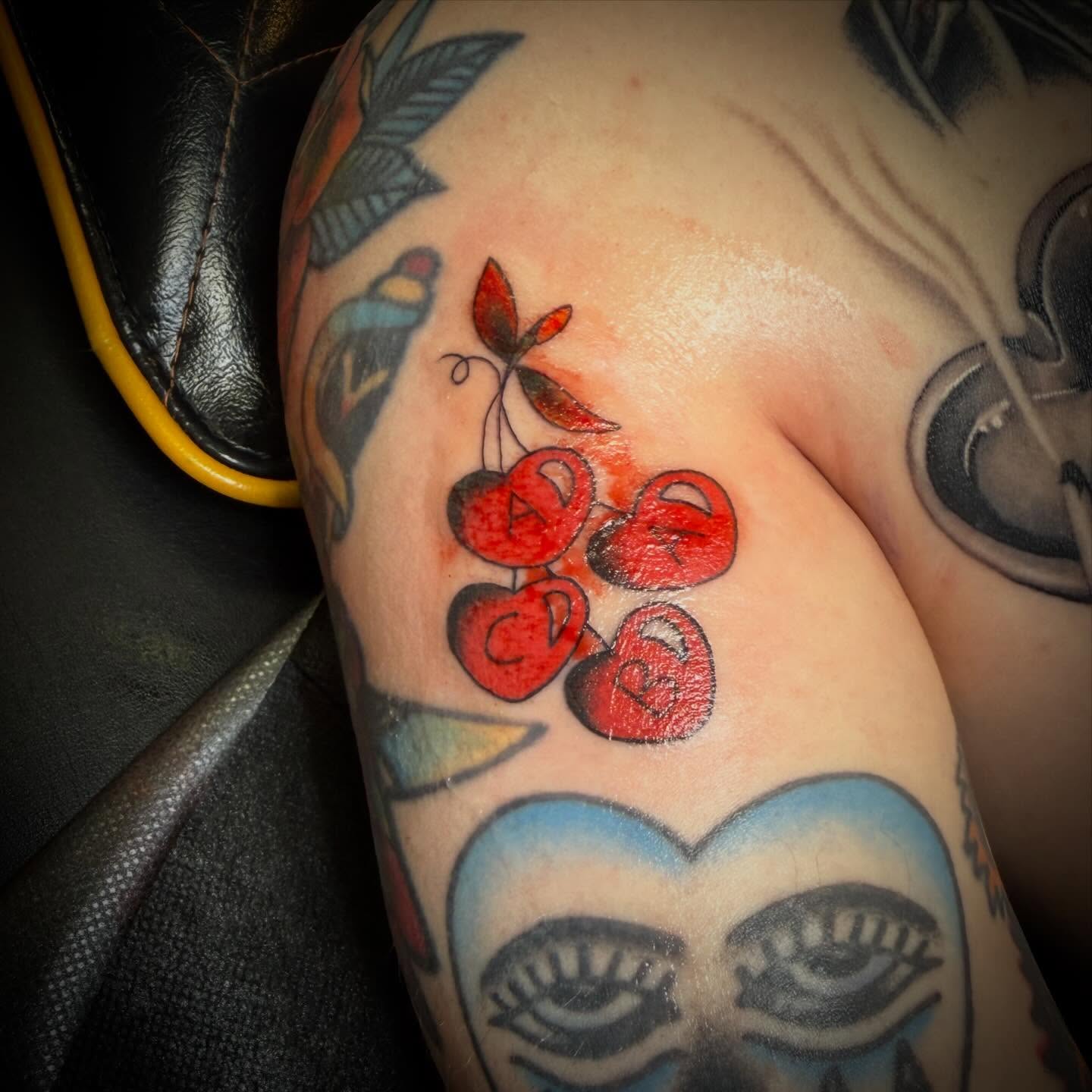 Cherries American traditional tattoo on the shoulder by ArJay Smith