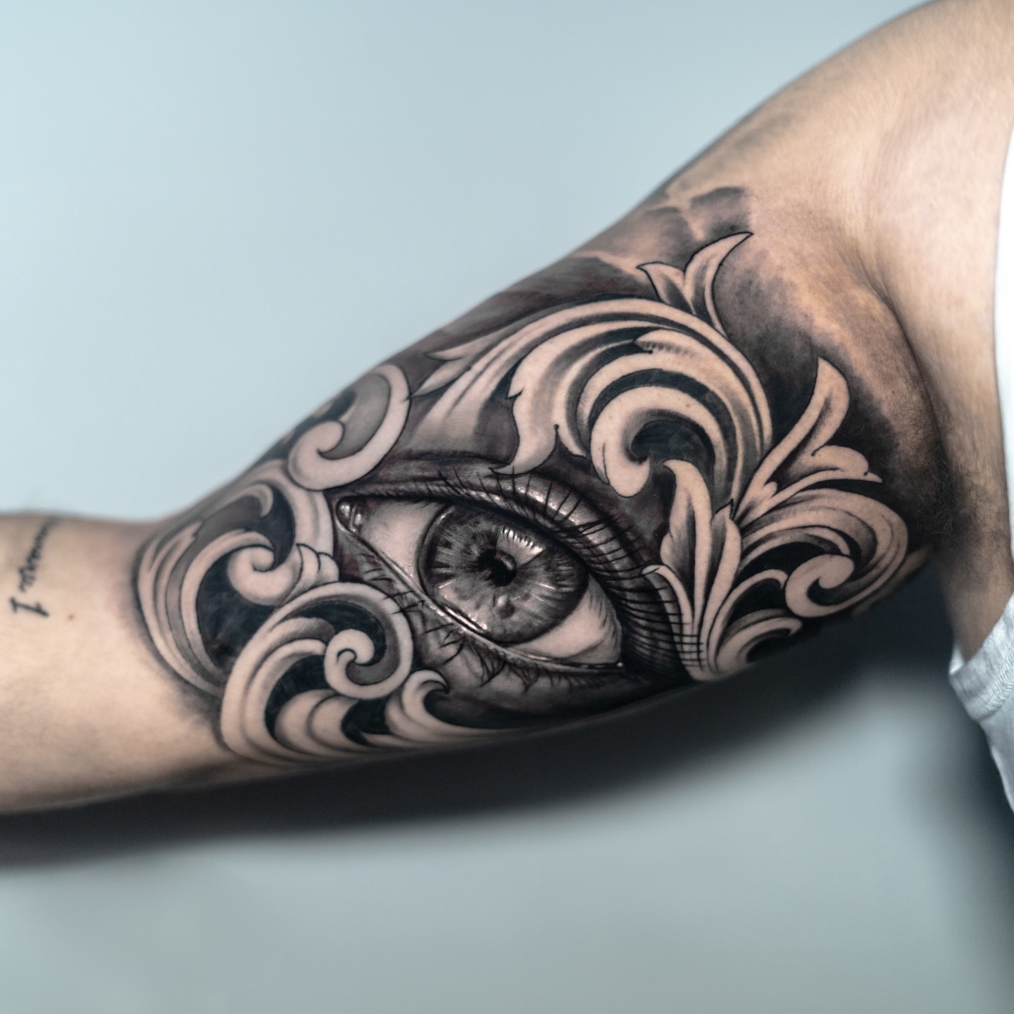 Eye with ornamental swirls Chicano tattoo on the forearm by James Jurado