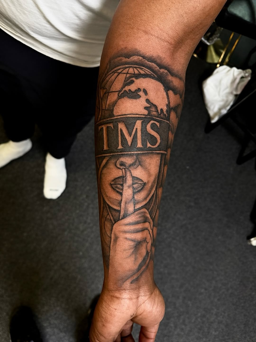 Woman with globe and letters realism tattoo on the forearm by JayyeSosa