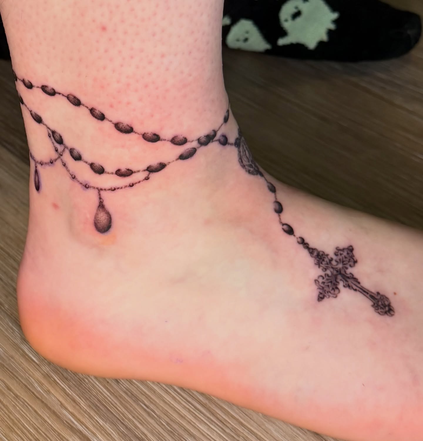 Rosary black and grey tattoo on the foot by Chiah