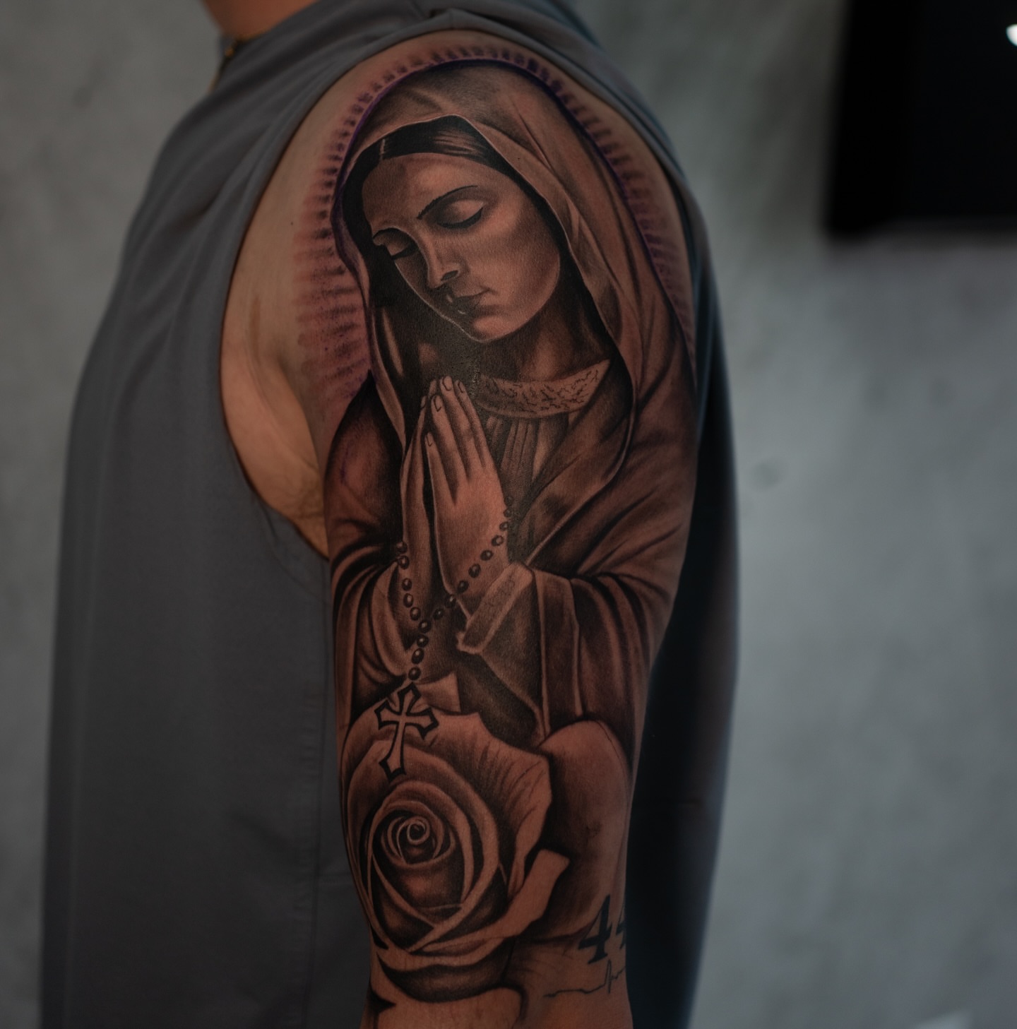 Religious figure praying realism tattoo on the forearm by Damon Valdez
