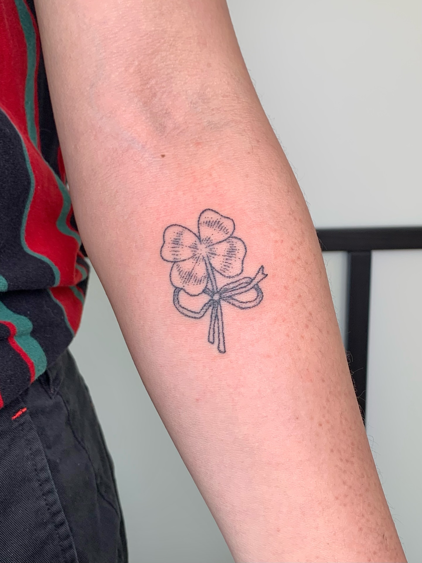Four-leaf clover black and grey tattoo on the forearm by Lex Lloyd