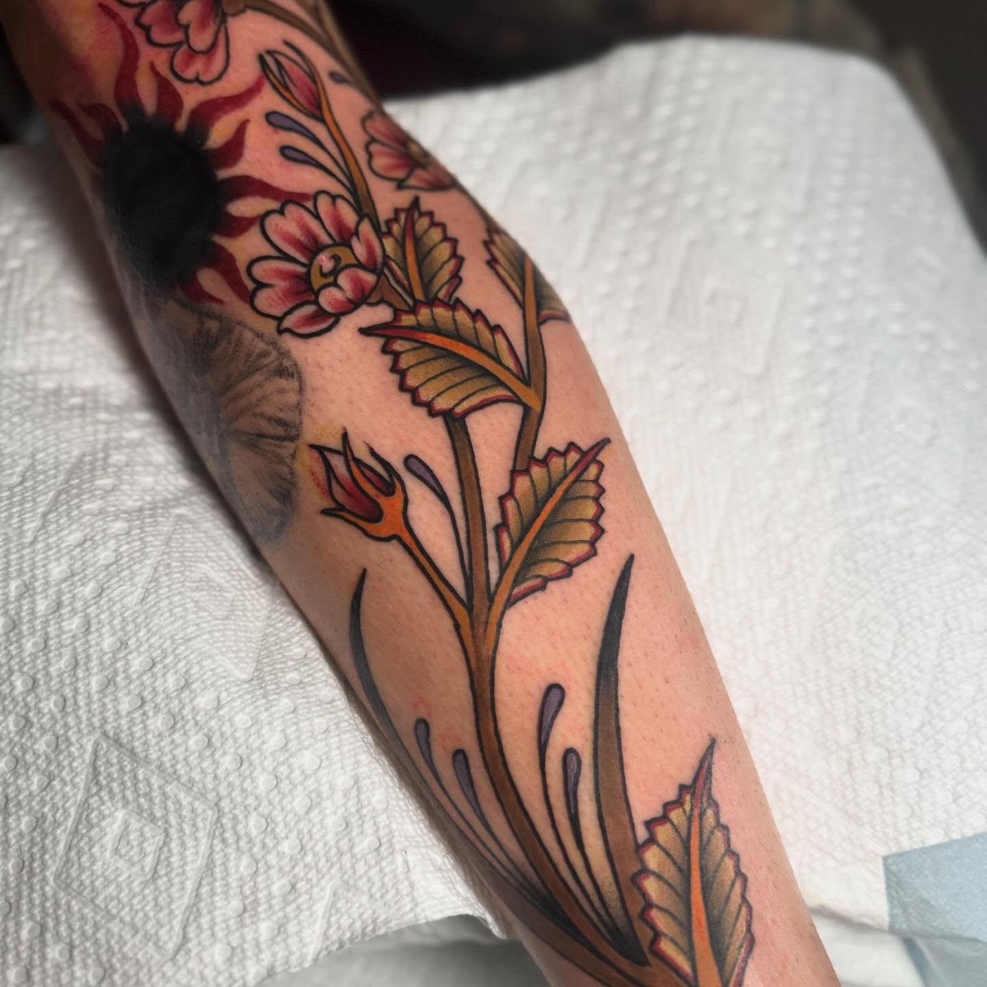 Floral design American traditional tattoo on the forearm by Dylan Walker