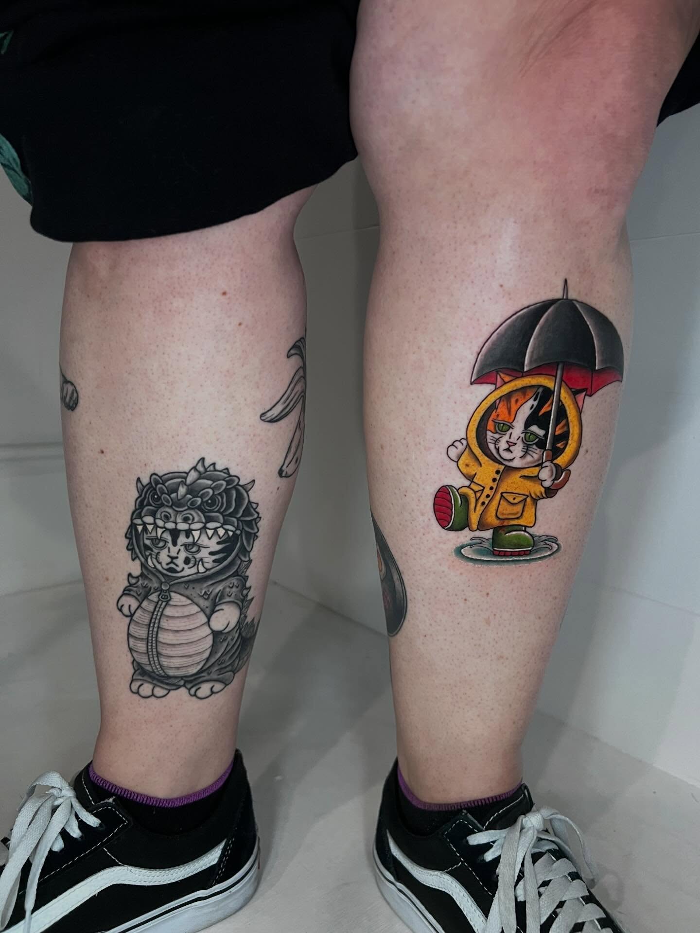 Cat in raincoat new school tattoo on the calf by Eoghann McGregor