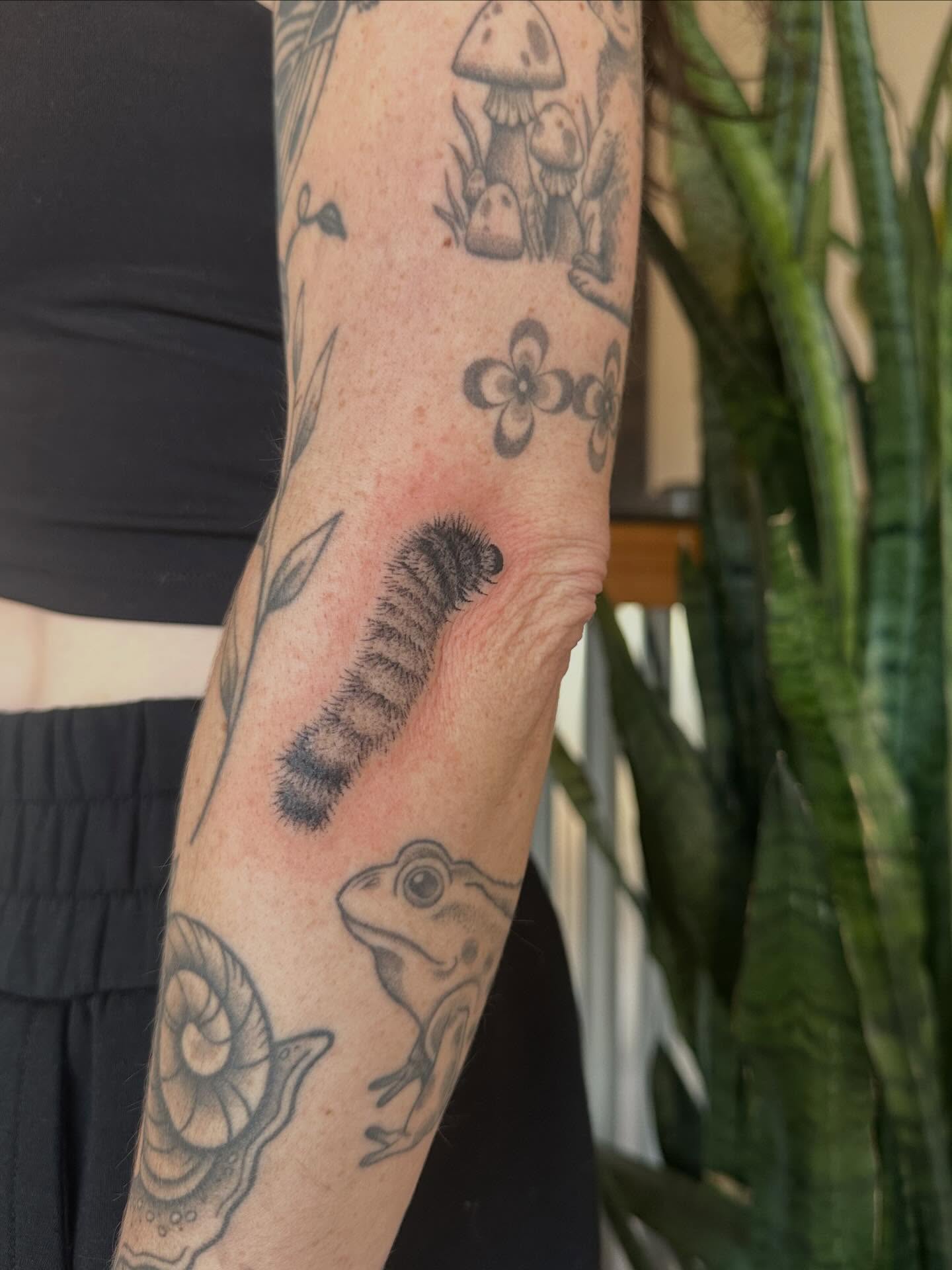 Caterpillar black and grey tattoo on the forearm by sara scak, Lakewood, Ohio