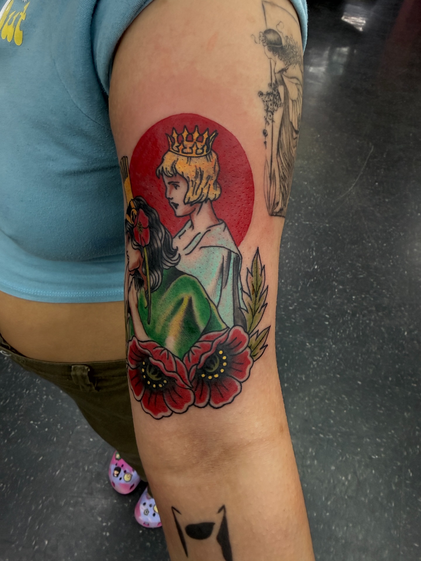 Royal couple with poppies American traditional tattoo on the forearm by Joshua Carter