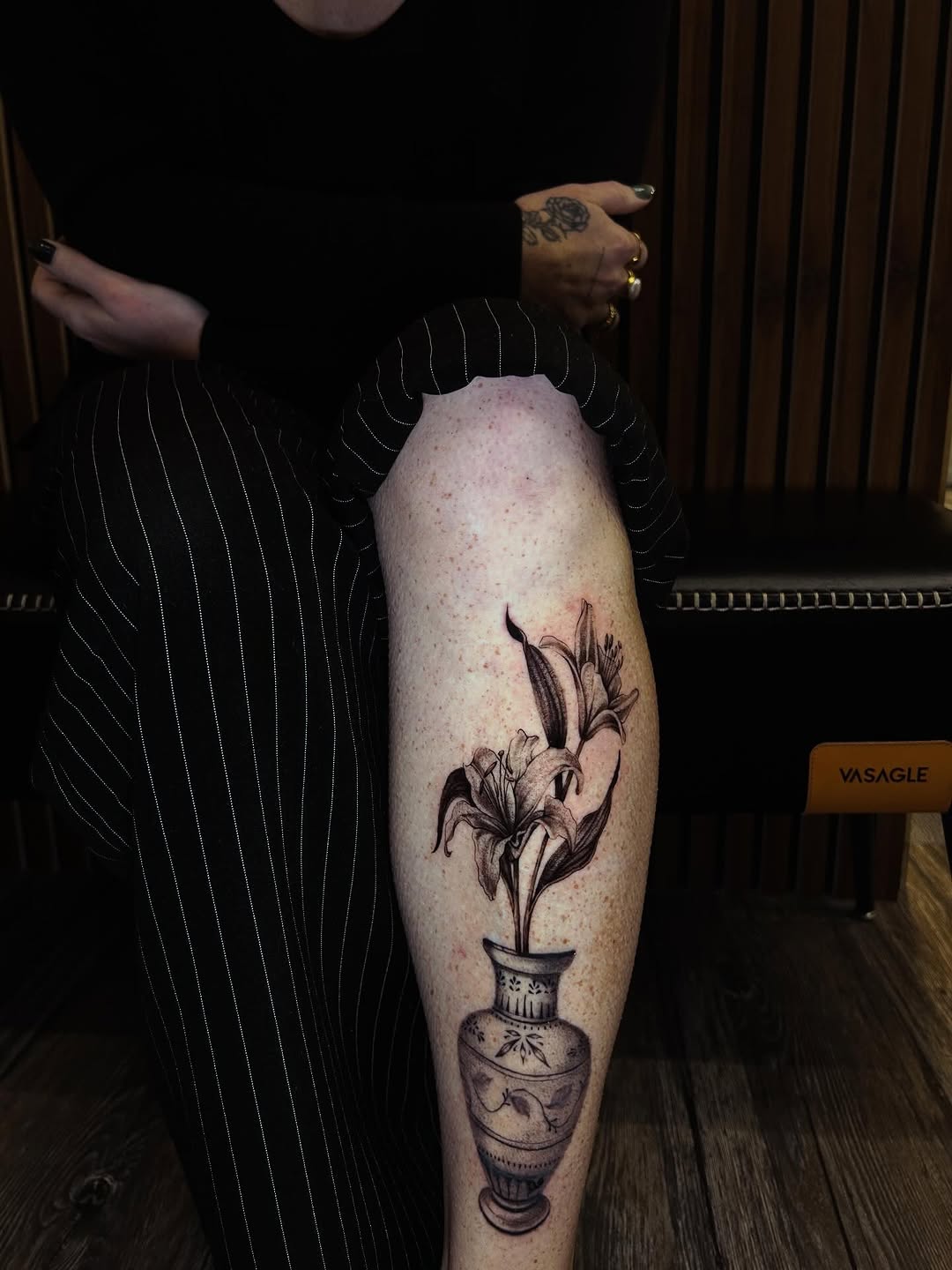 Lilies in a vase fine line tattoo on the thigh by J