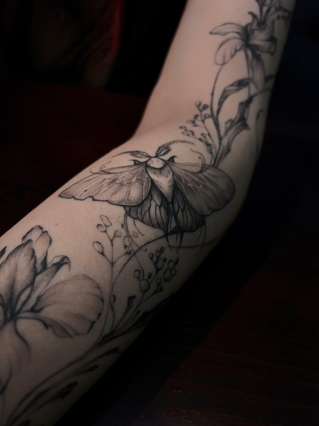 Butterfly and flowers realism tattoo on the forearm by Nina Fedorchenko