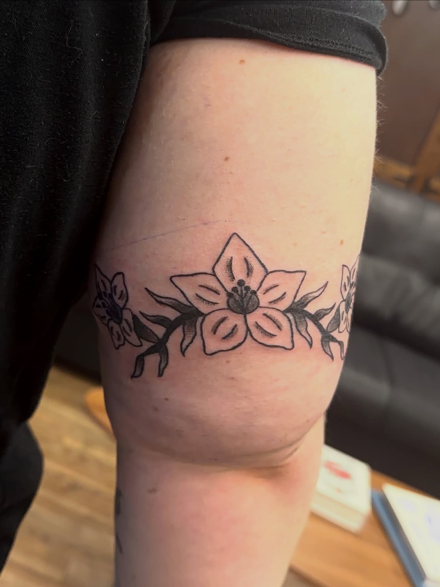 Flower black and grey tattoo on the thigh by Giana Masso
