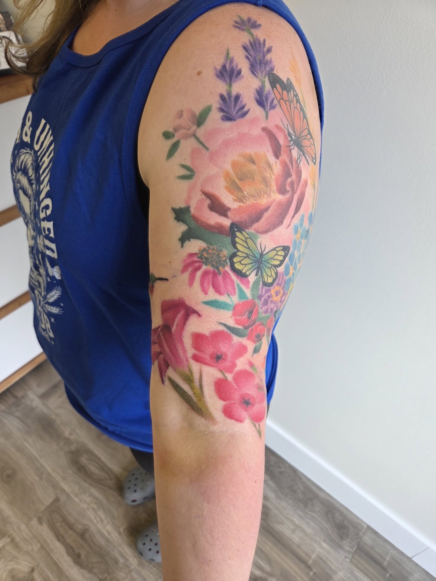 Floral bouquet watercolor tattoo on the forearm by Buk