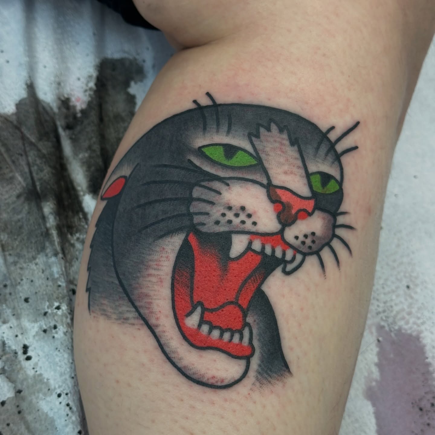Angry cat American traditional tattoo on the forearm by Christian Rieben