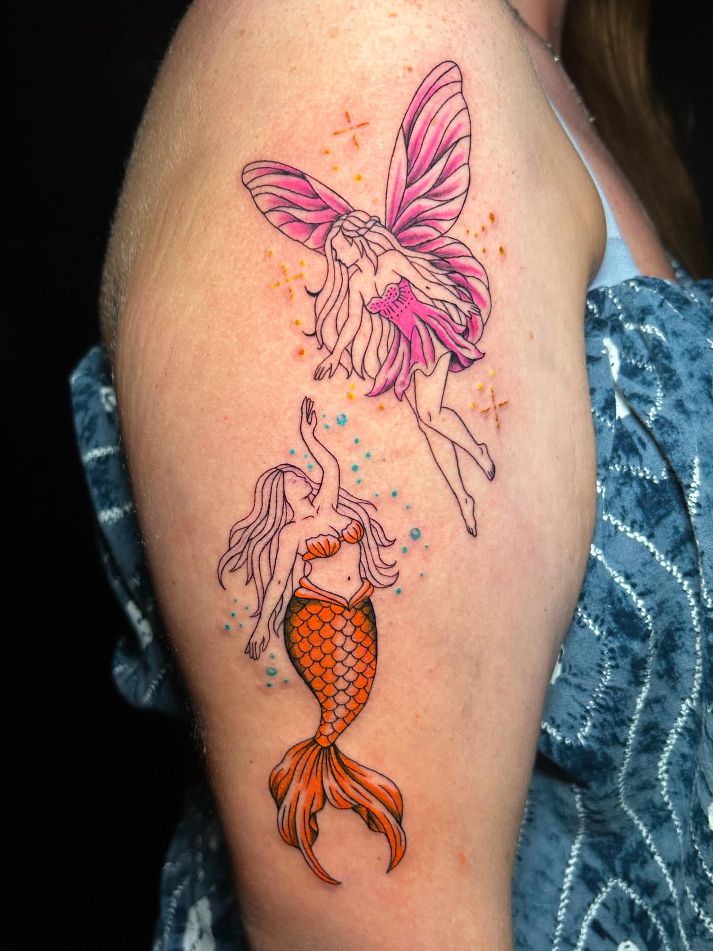 Mermaid and fairy dotwork tattoo on the upper arm by Maia Pizarro