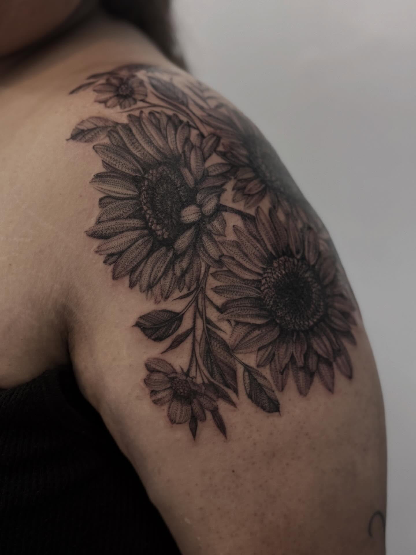Sunflowers black and grey tattoo on the shoulder by Tianna Osborne