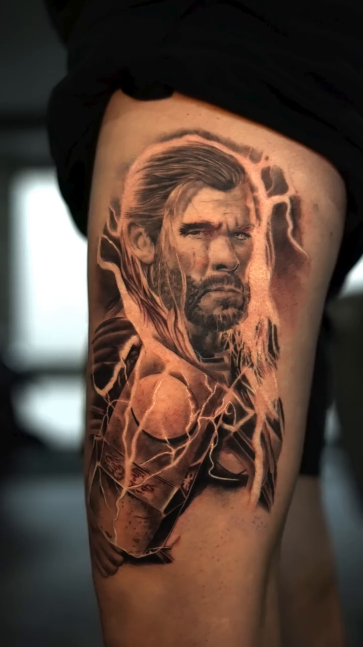 Thor portrait with lightning realism tattoo on the thigh by Remko