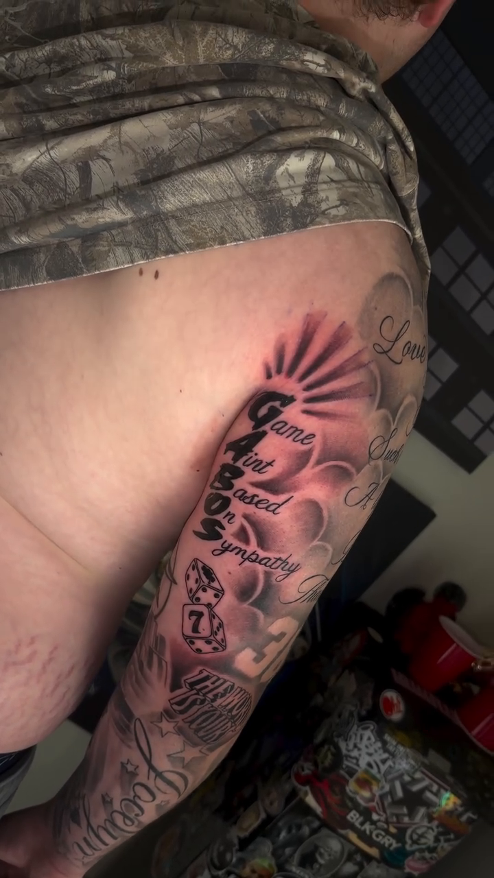 Religious imagery and text realism tattoo by Danny Vazquez