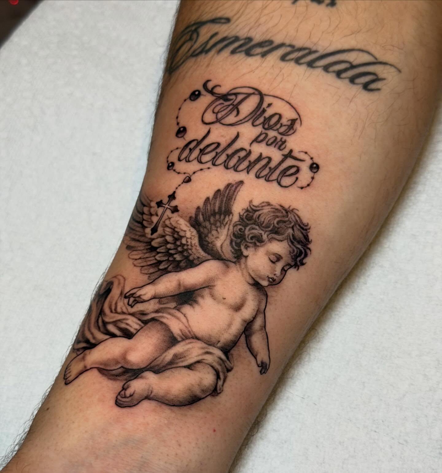 Angel with rosary black and grey tattoo on the forearm by Marquis Neal
