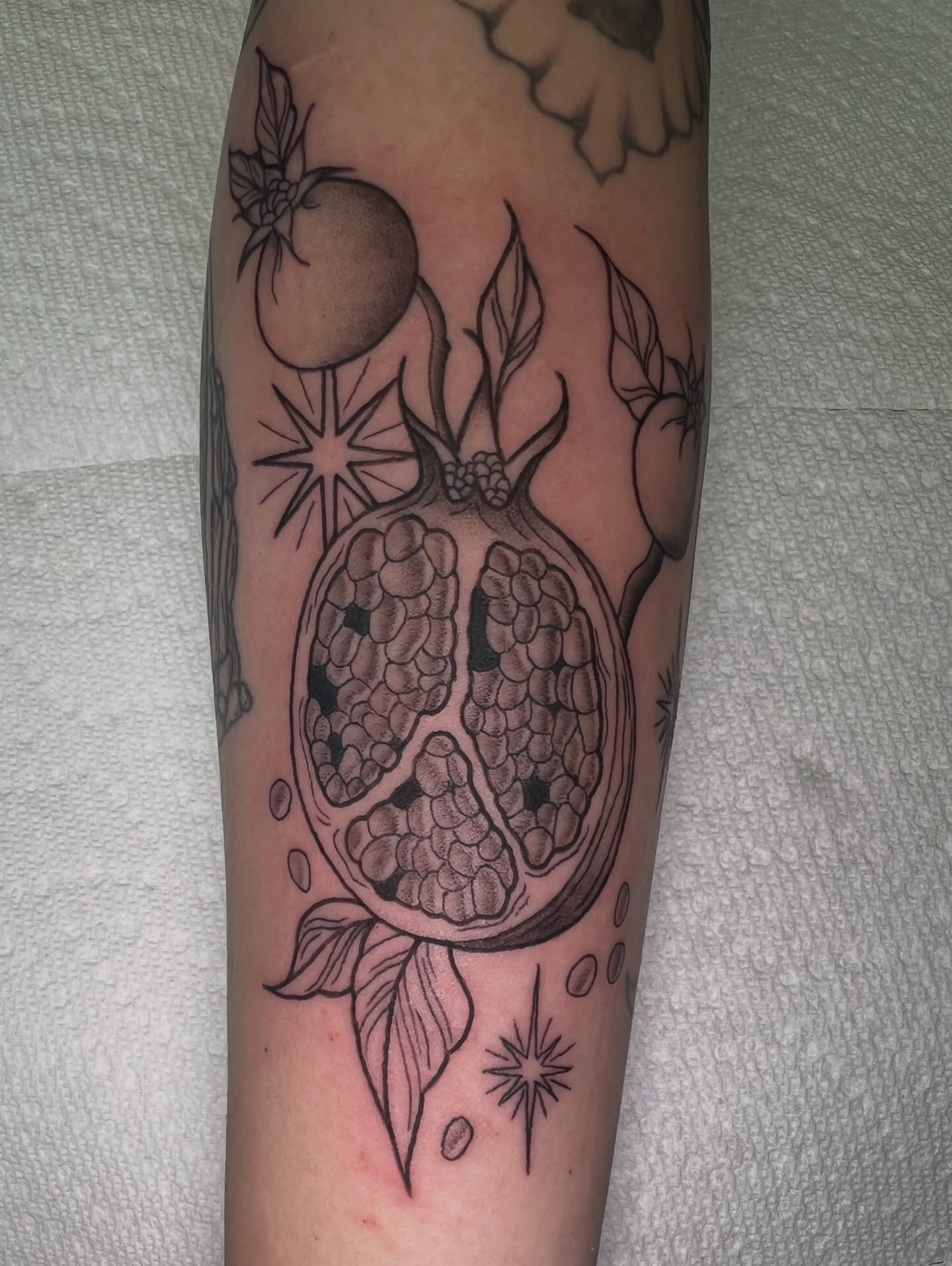 Pomegranate realism tattoo on the forearm by Blair Schwartz, Asbury Park, New Jersey