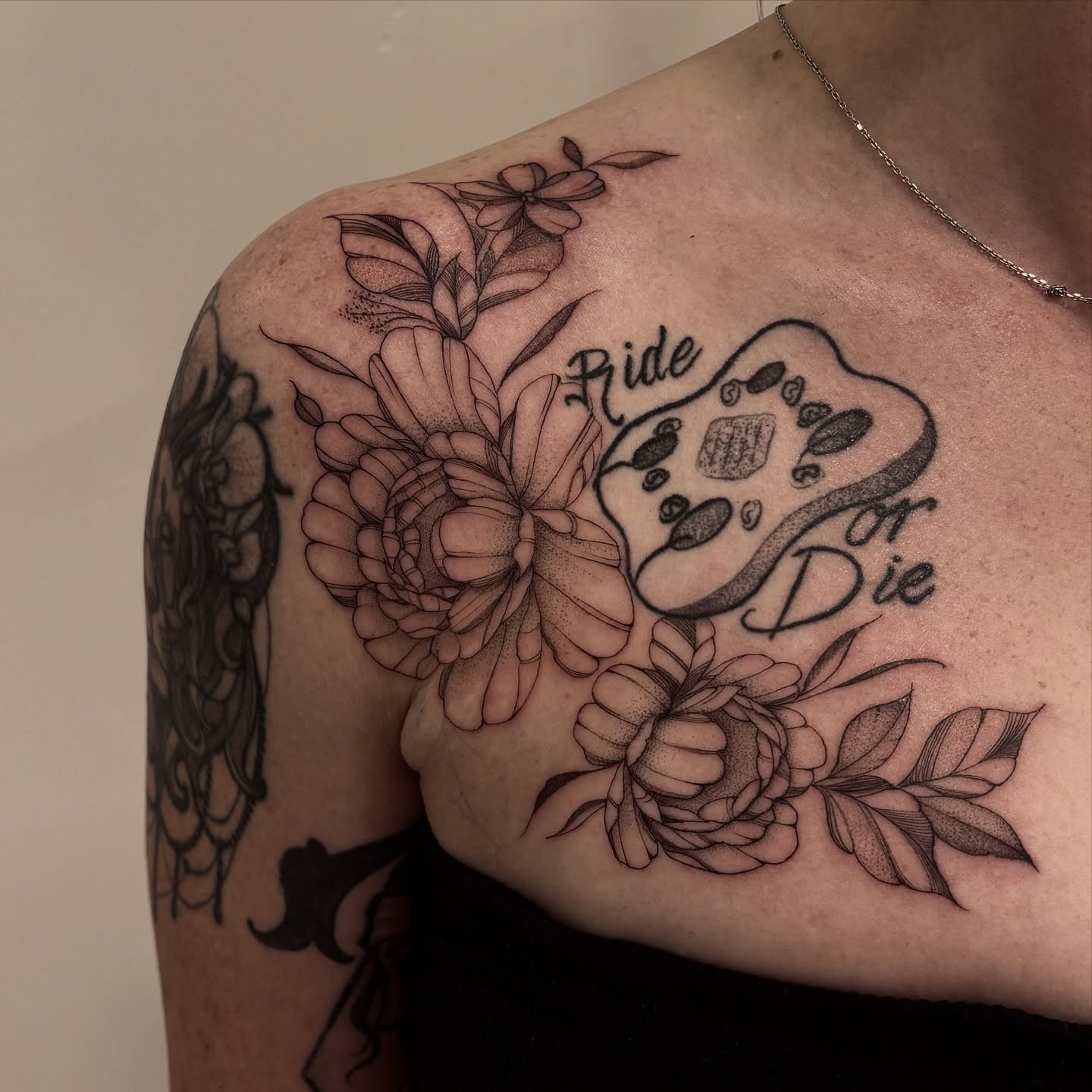 Floral arrangement with gaming controller dotwork tattoo on the shoulder by Tayler, Tooele, Utah
