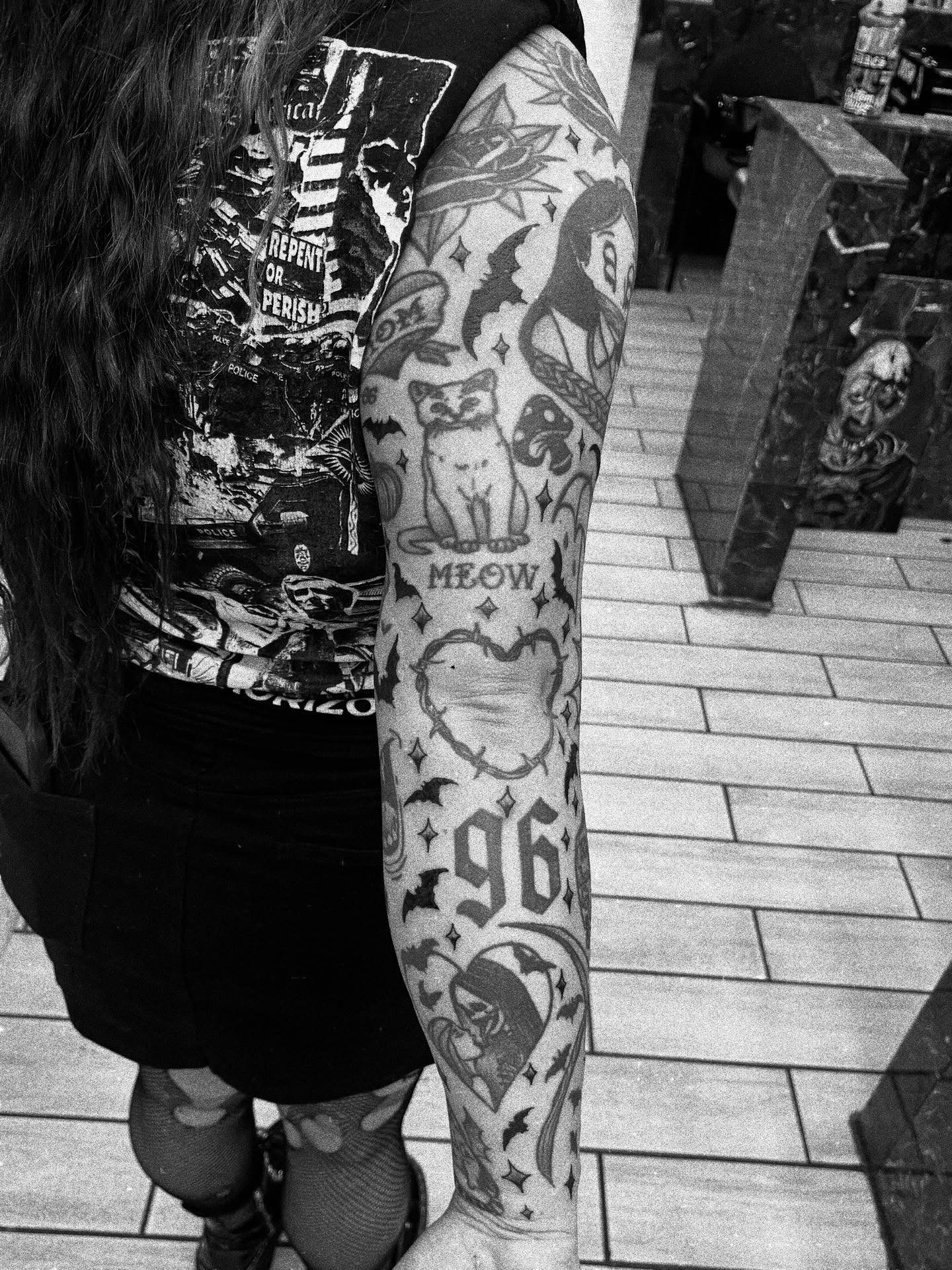 Cat and bat American traditional tattoo on the forearm by Sean Gallagher