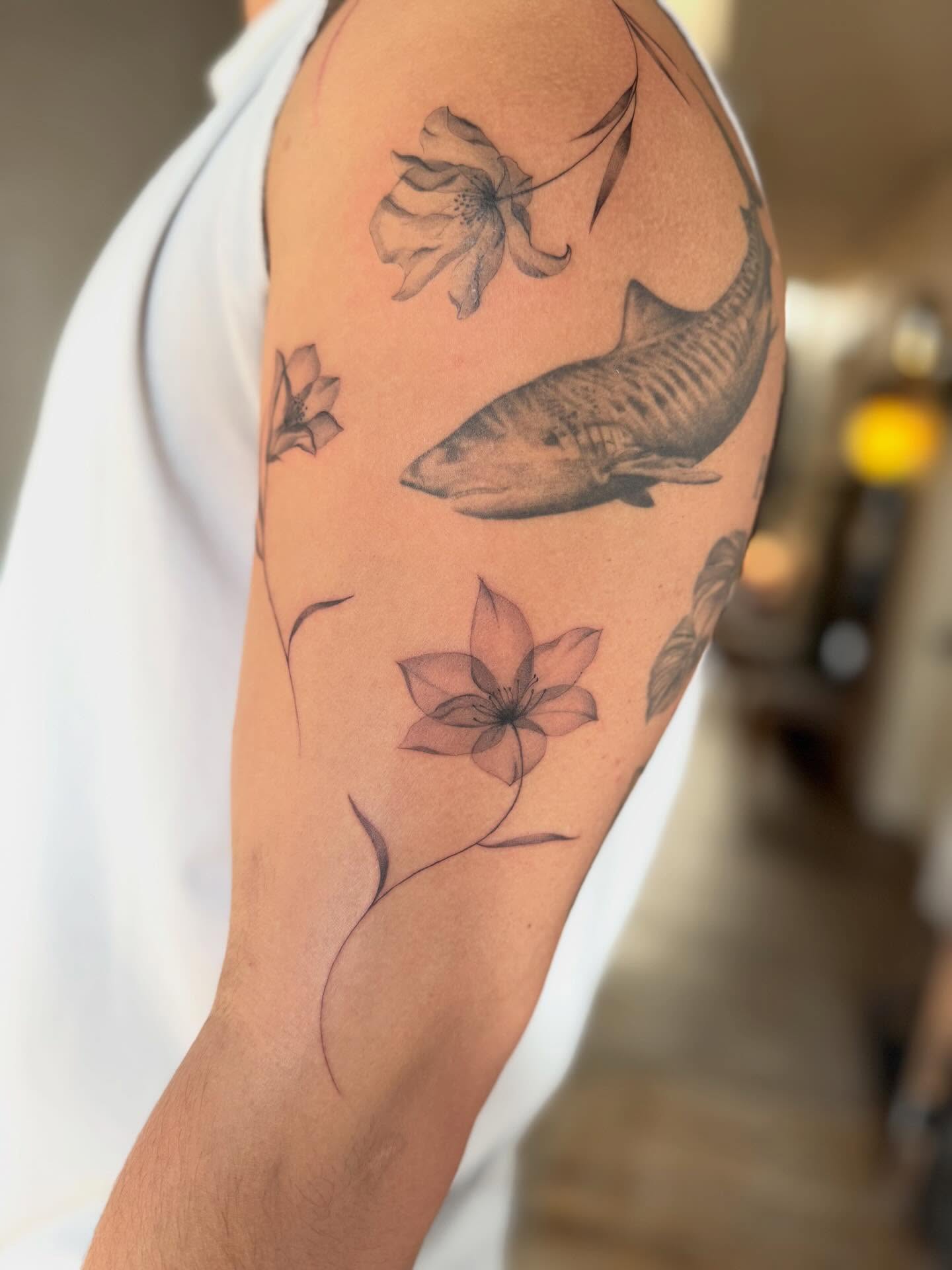 Shark and flowers black and grey tattoo on the upper arm by Lily Cuoio~ Seattle