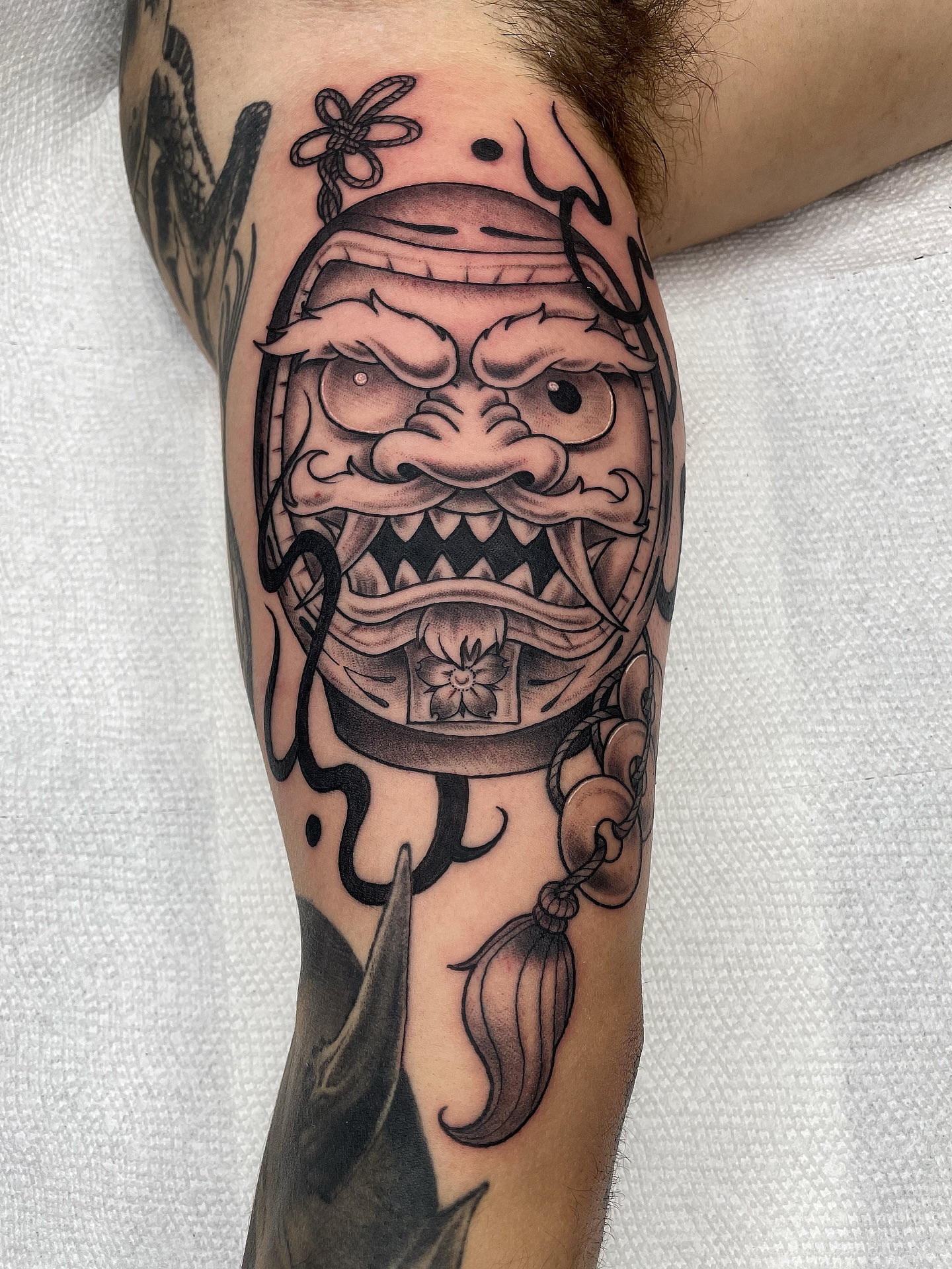 Demon mask American traditional tattoo on the forearm by Alex Ortiz