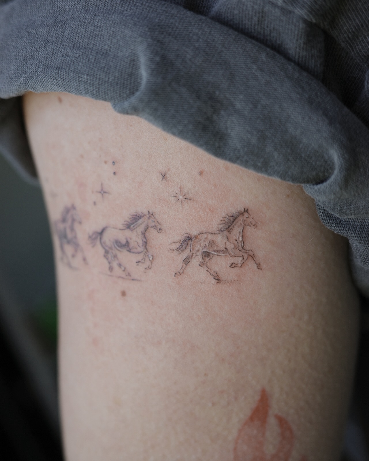 Horses black and grey tattoo on the thigh by It’s ya girl, KB