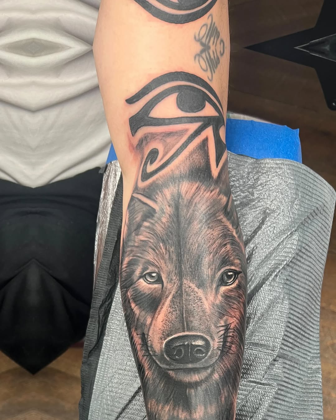 Wolf and eye of horus realism tattoo on the forearm by Watson Gutkowski