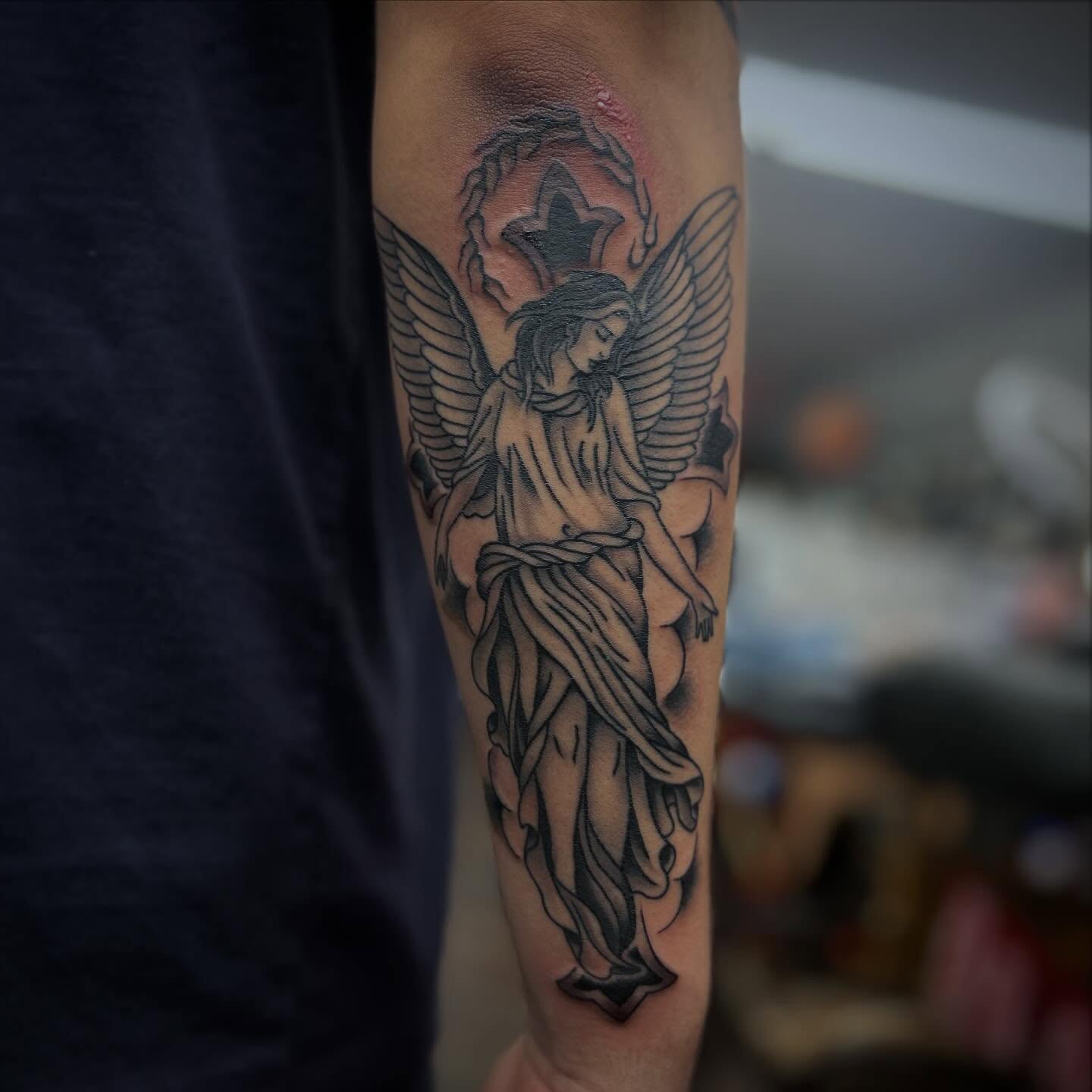 Angel black and grey tattoo on the forearm by Matthew Tillman