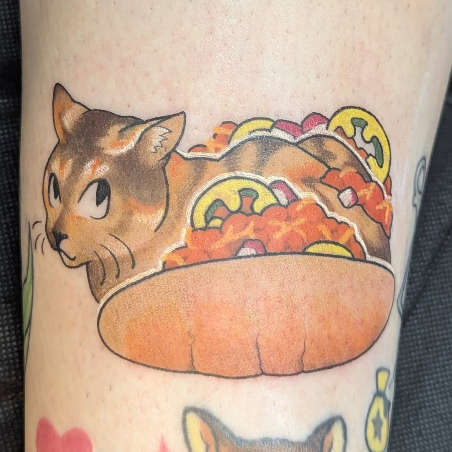 Cat in taco illustrative tattoo on the forearm by Spencer Jennings, Westland, Michigan