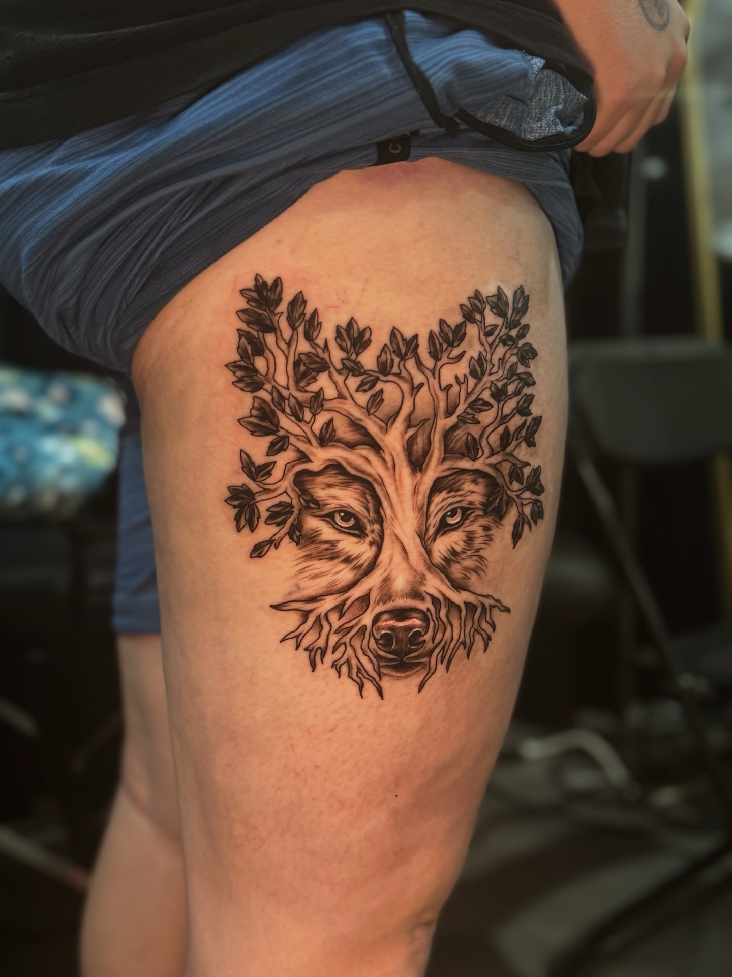 Tree with animal face realism tattoo on the thigh by Lily Nurnberger