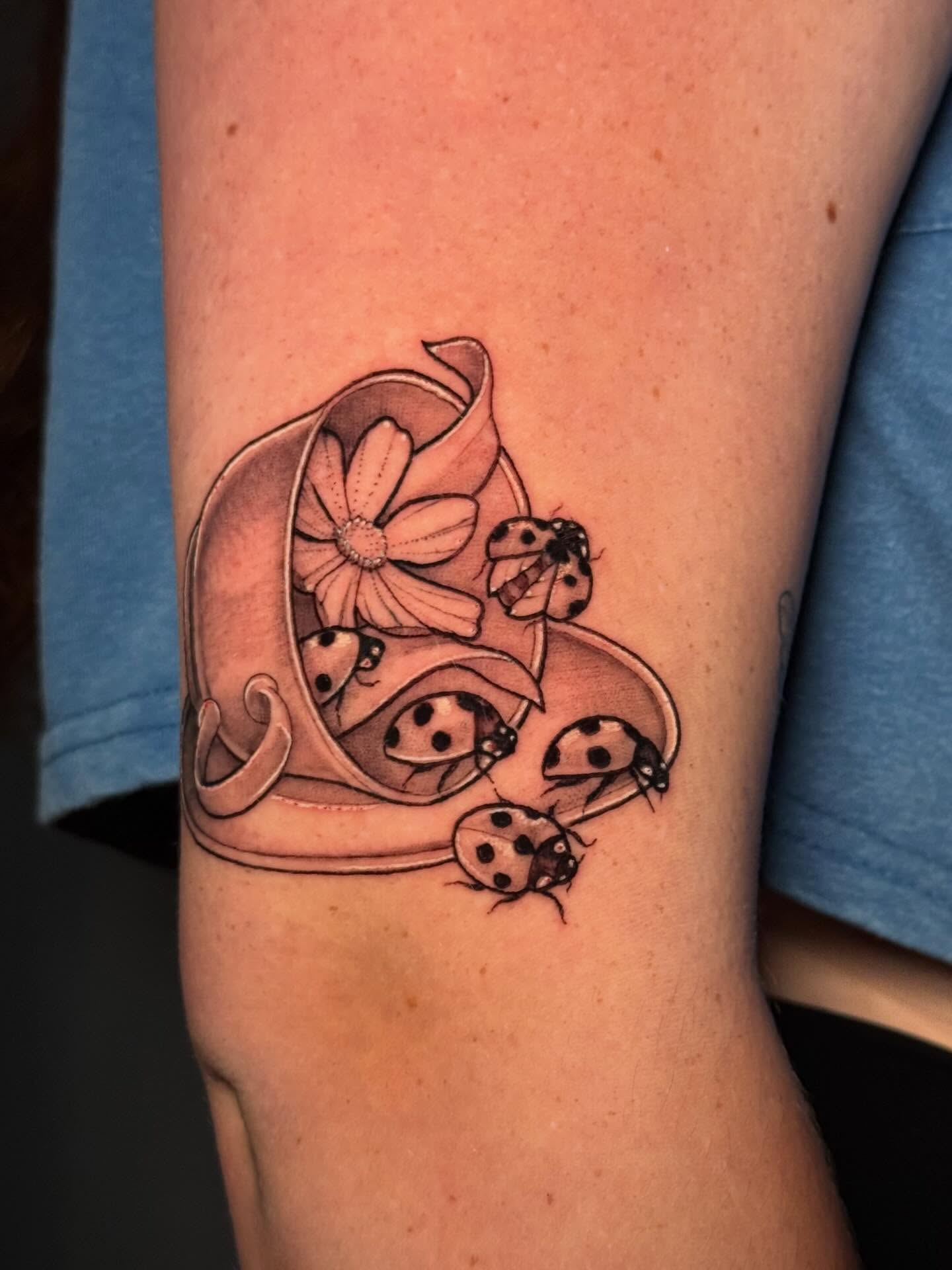 Ladybugs and flower black and grey tattoo on the forearm by Andreanna Rosemarie Gabranidis, Pennsauken, New Jersey