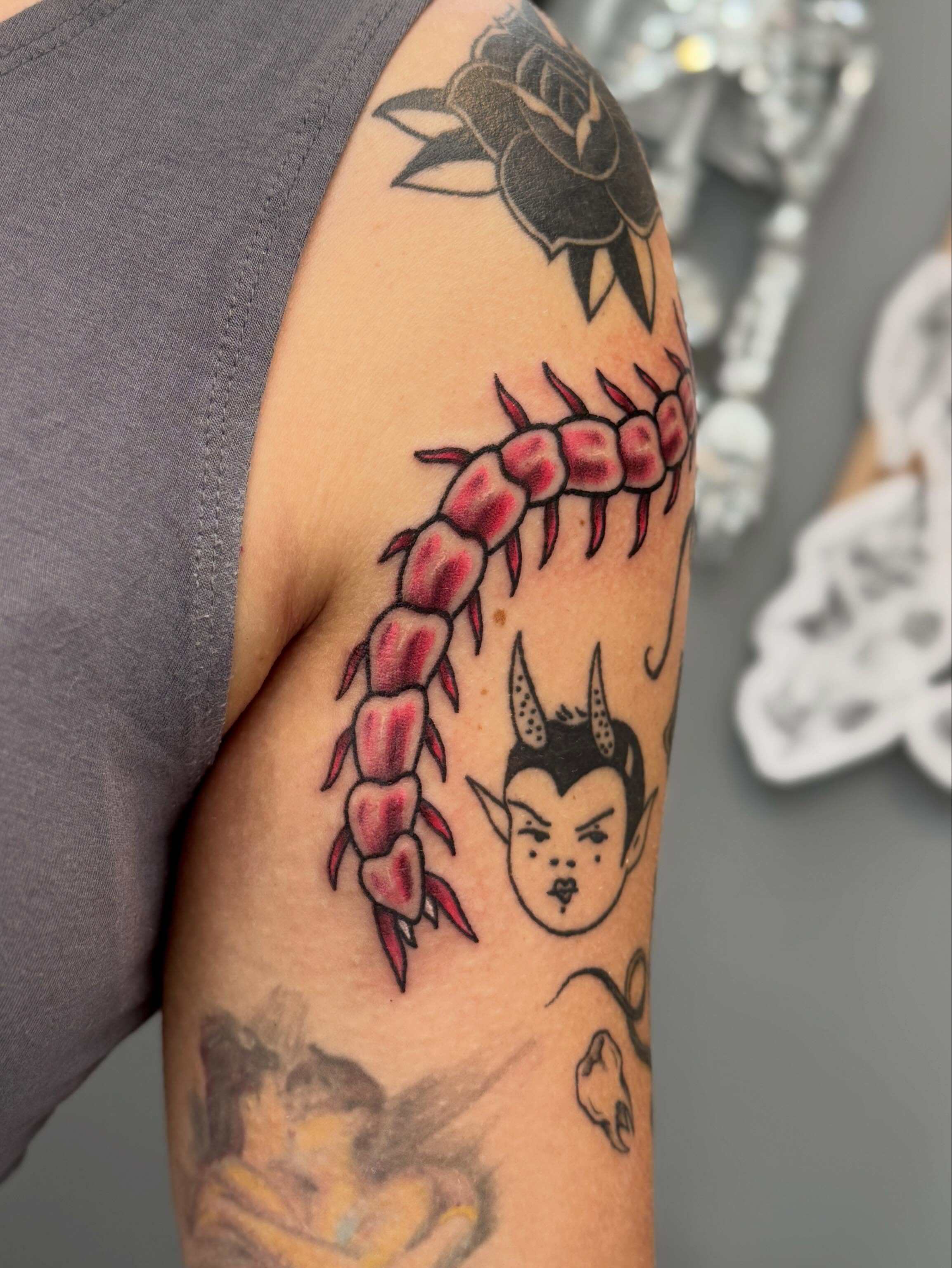 Centipede and devil head American traditional tattoo on the forearm by Kamakana Pankiwska