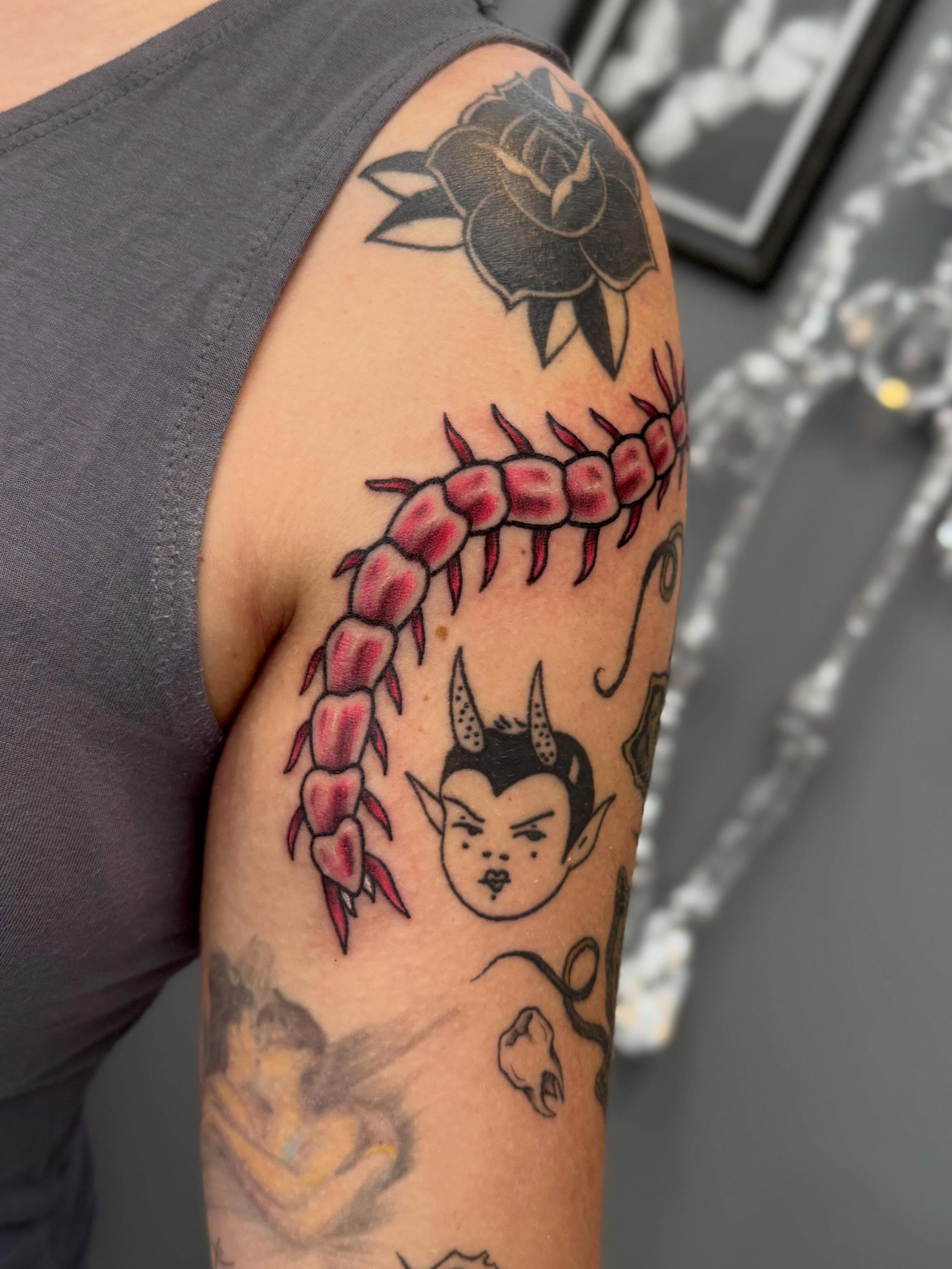 Spine with spikes American traditional tattoo on the upper arm by Kamakana Pankiwska